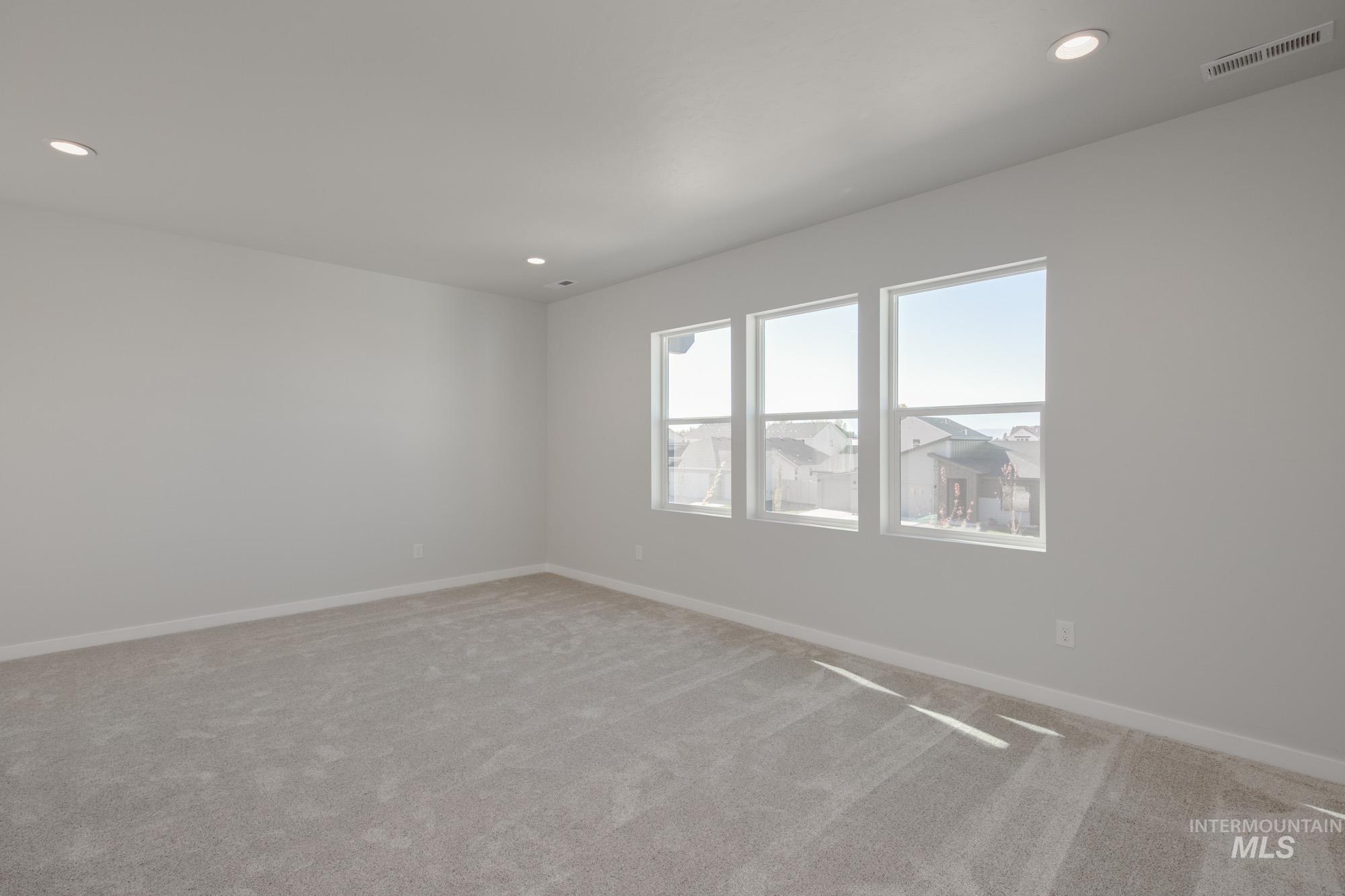 Empty room featuring carpet flooring and recessed lighting