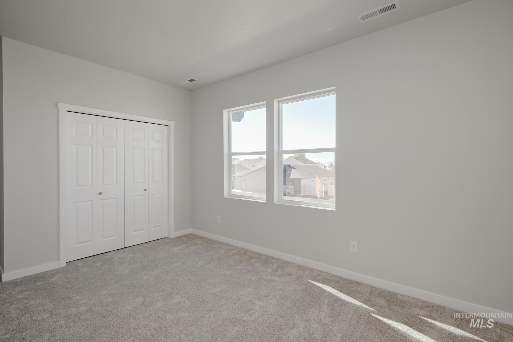 Unfurnished bedroom with carpet flooring and a closet