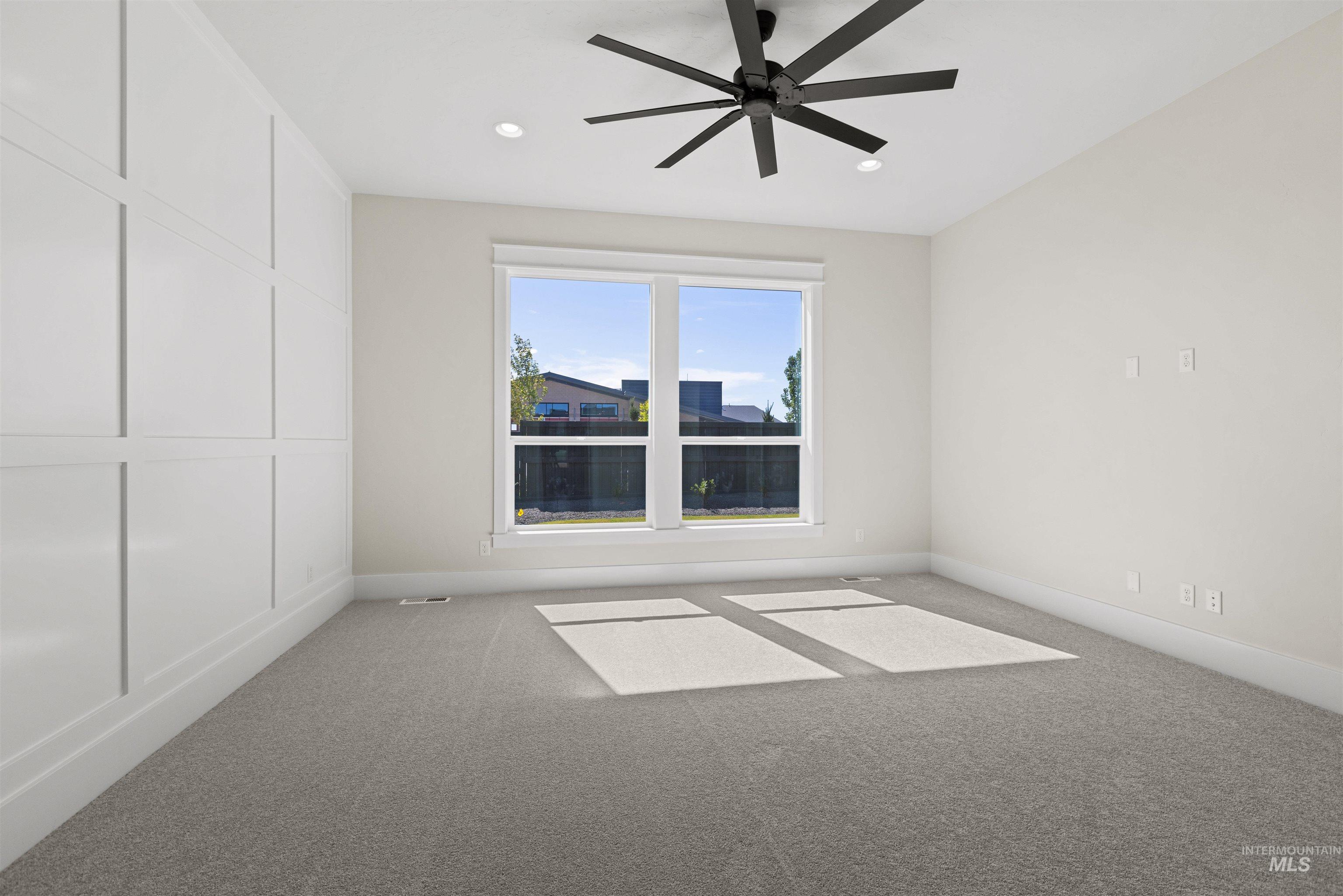 Empty room featuring carpet flooring, a ceiling fan, and recessed lighting