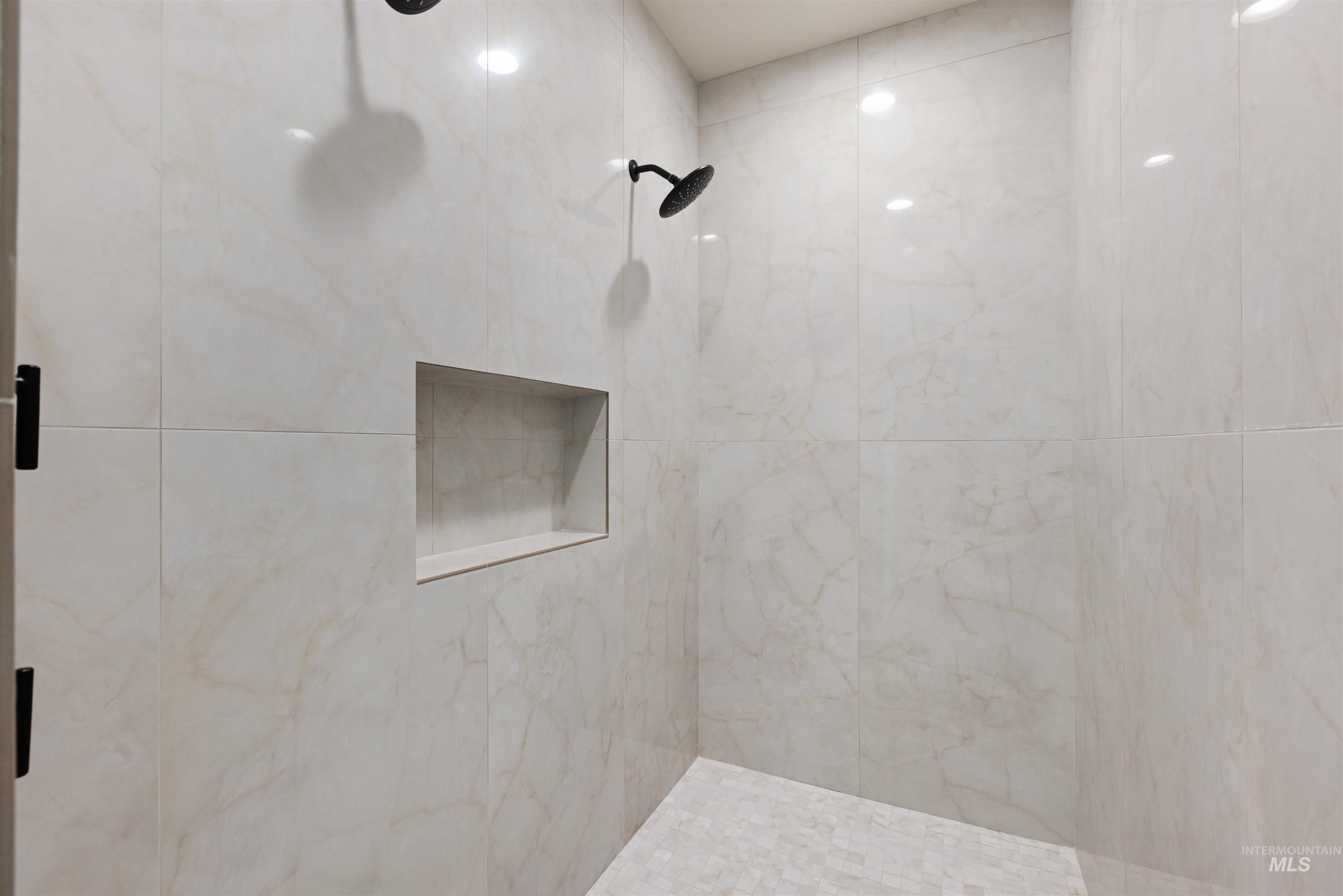 Bathroom featuring a tile shower