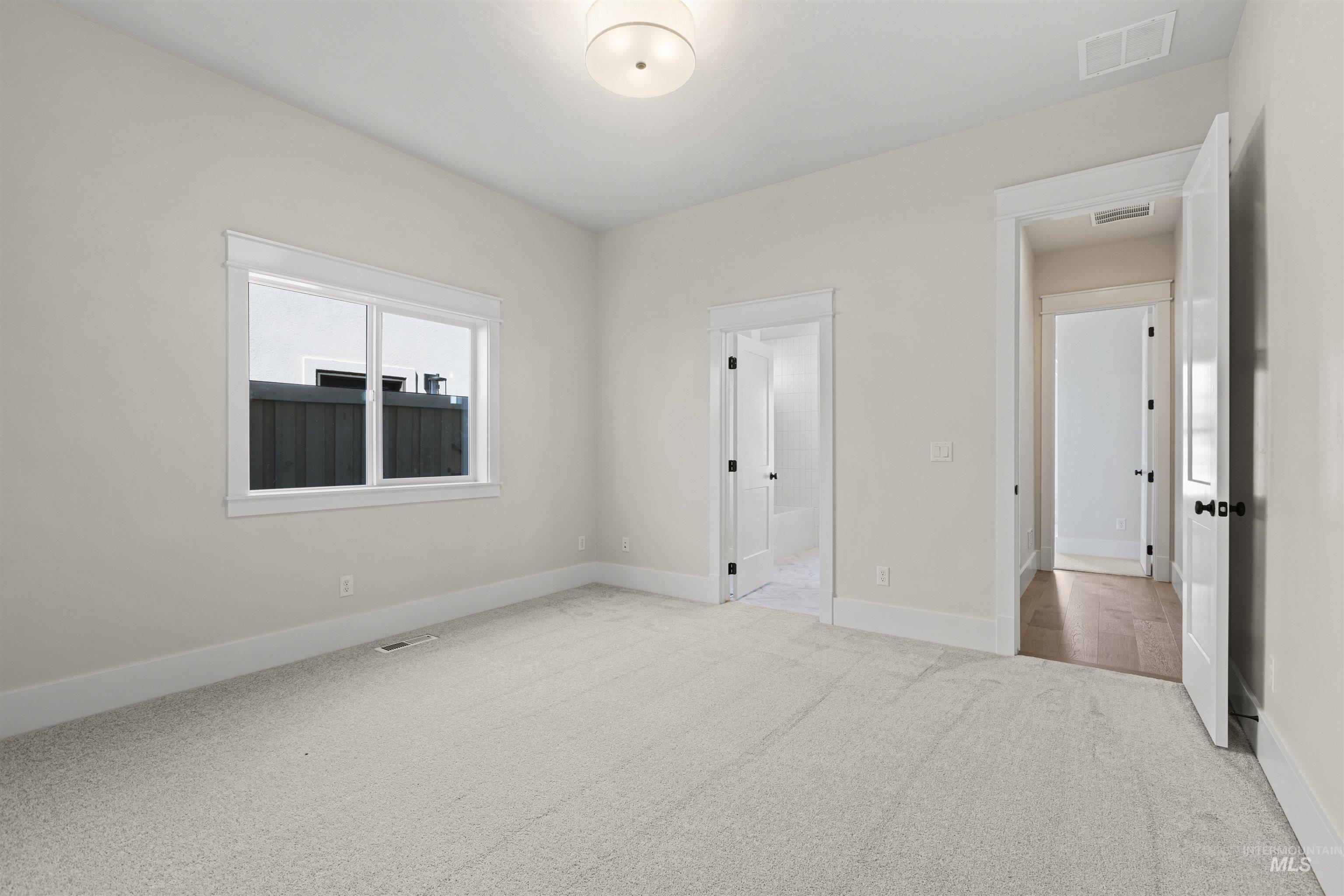 Unfurnished bedroom featuring carpet floors and baseboards