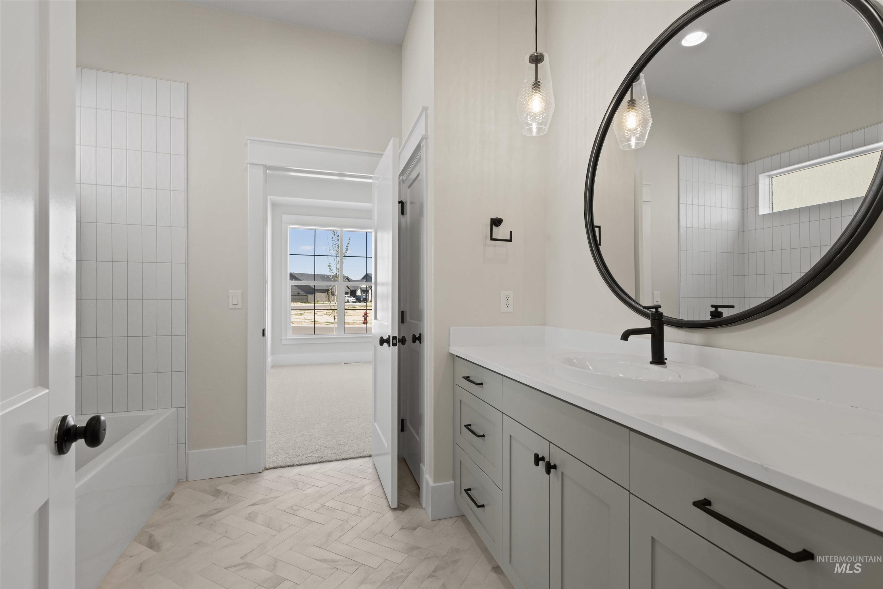 Full bath featuring vanity and baseboards