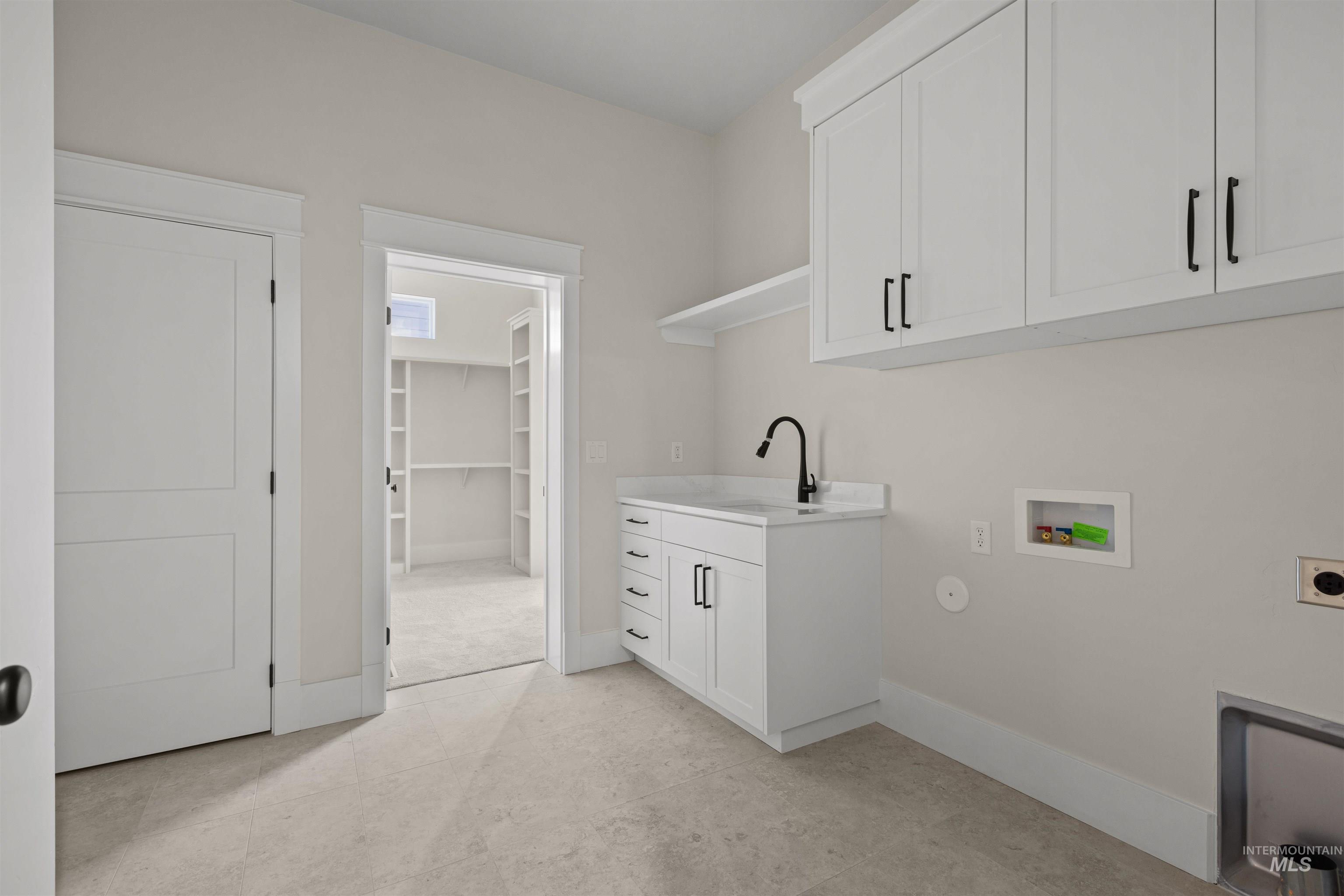 Laundry room featuring electric dryer hookup, hookup for a washing machine, cabinet space, and hookup for a gas dryer