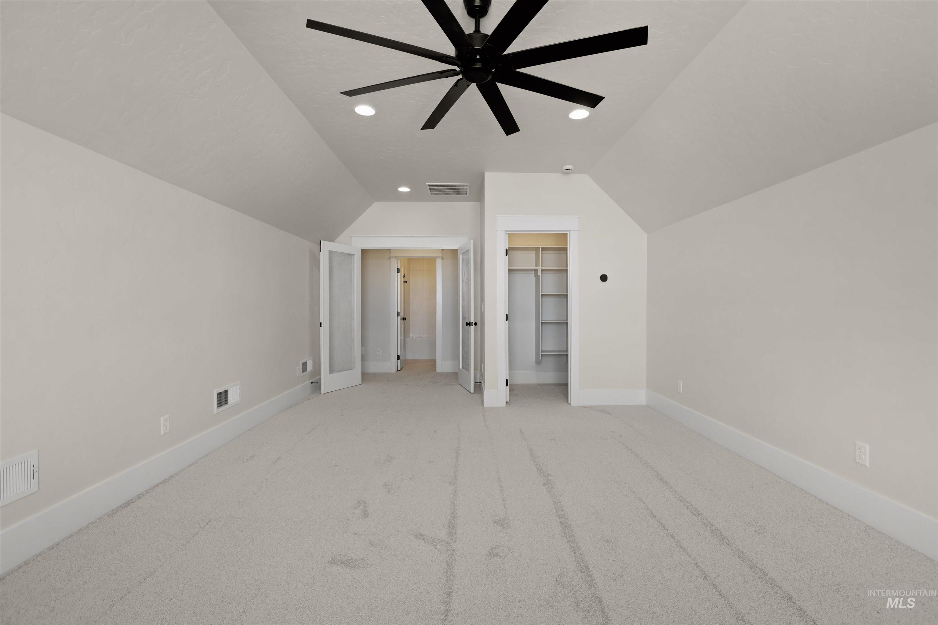 Additional living space with lofted ceiling, a ceiling fan, carpet floors, and recessed lighting