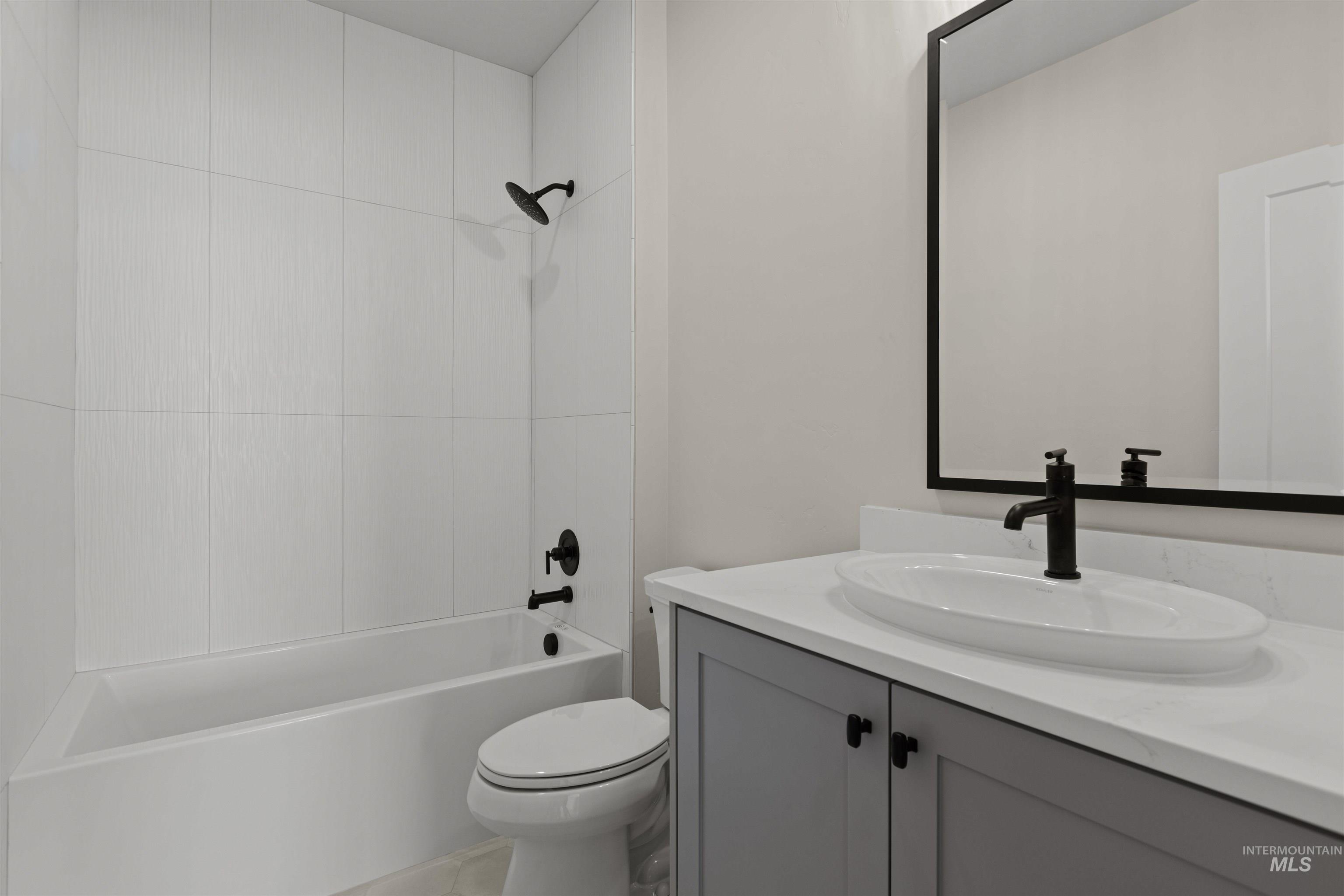 Bathroom with vanity and tub / shower combination