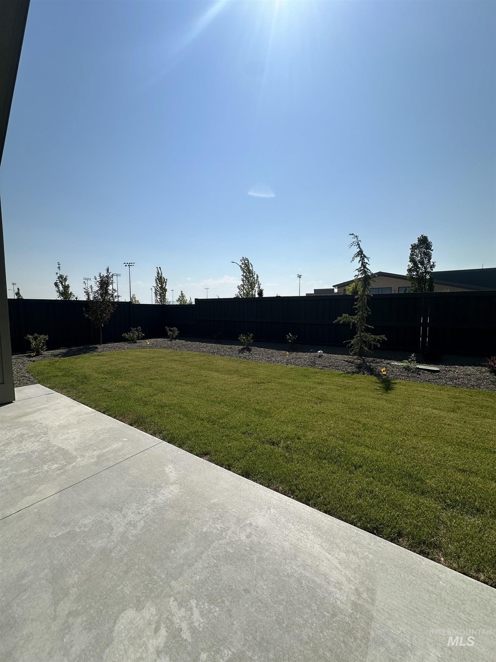 Fenced backyard with a patio area