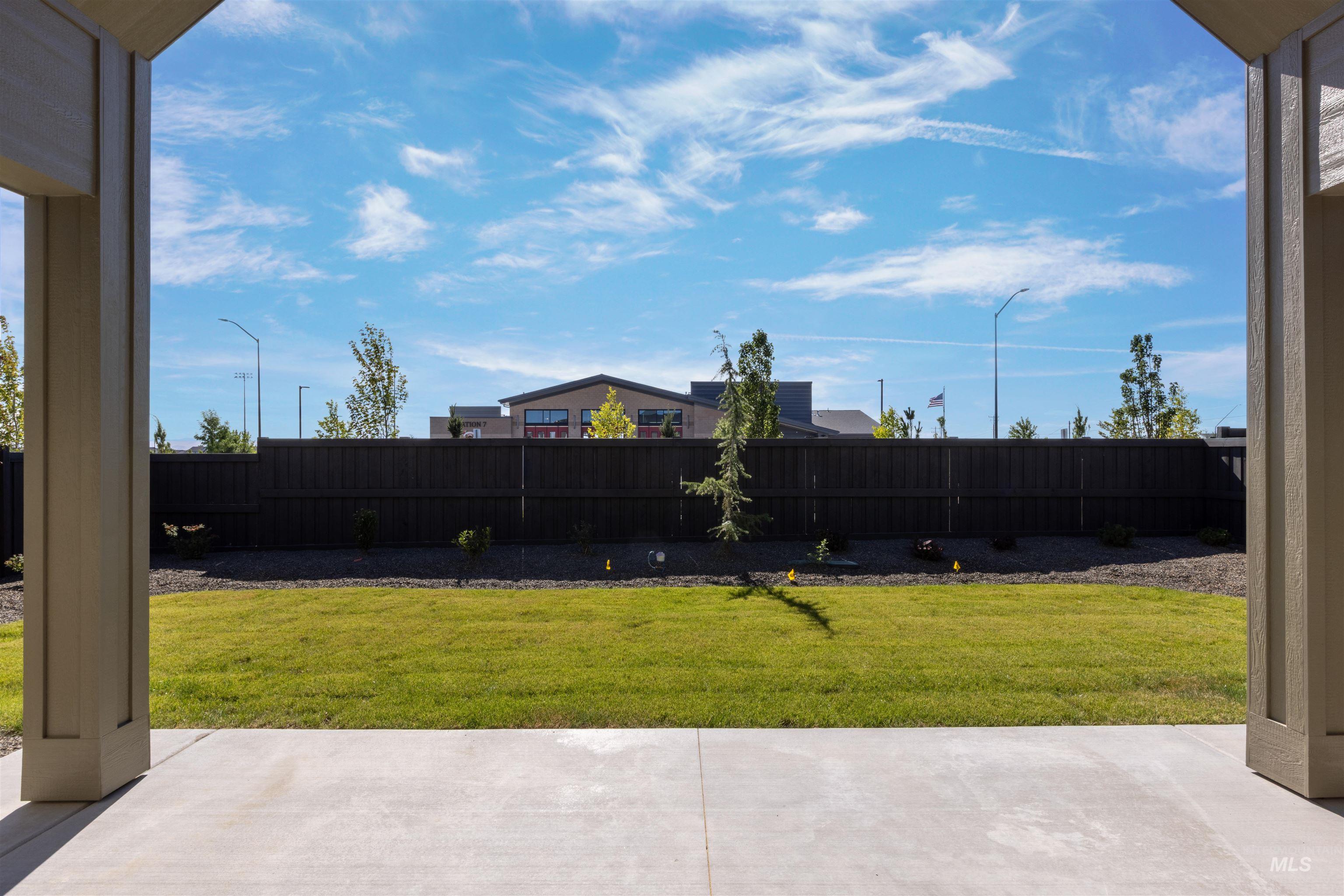 Fenced backyard with a patio