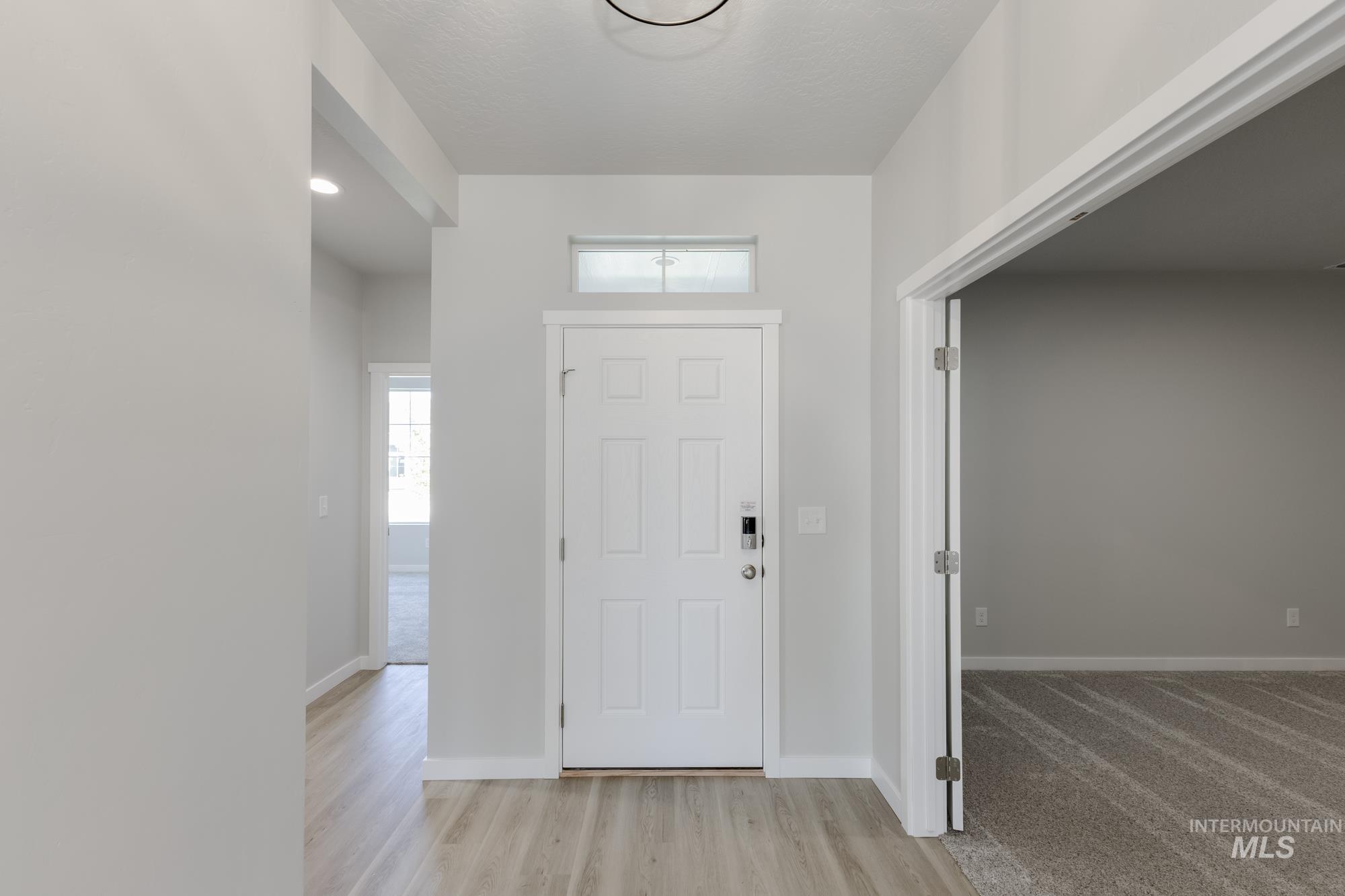 Entrance foyer featuring light wood-style floors and recessed lighting