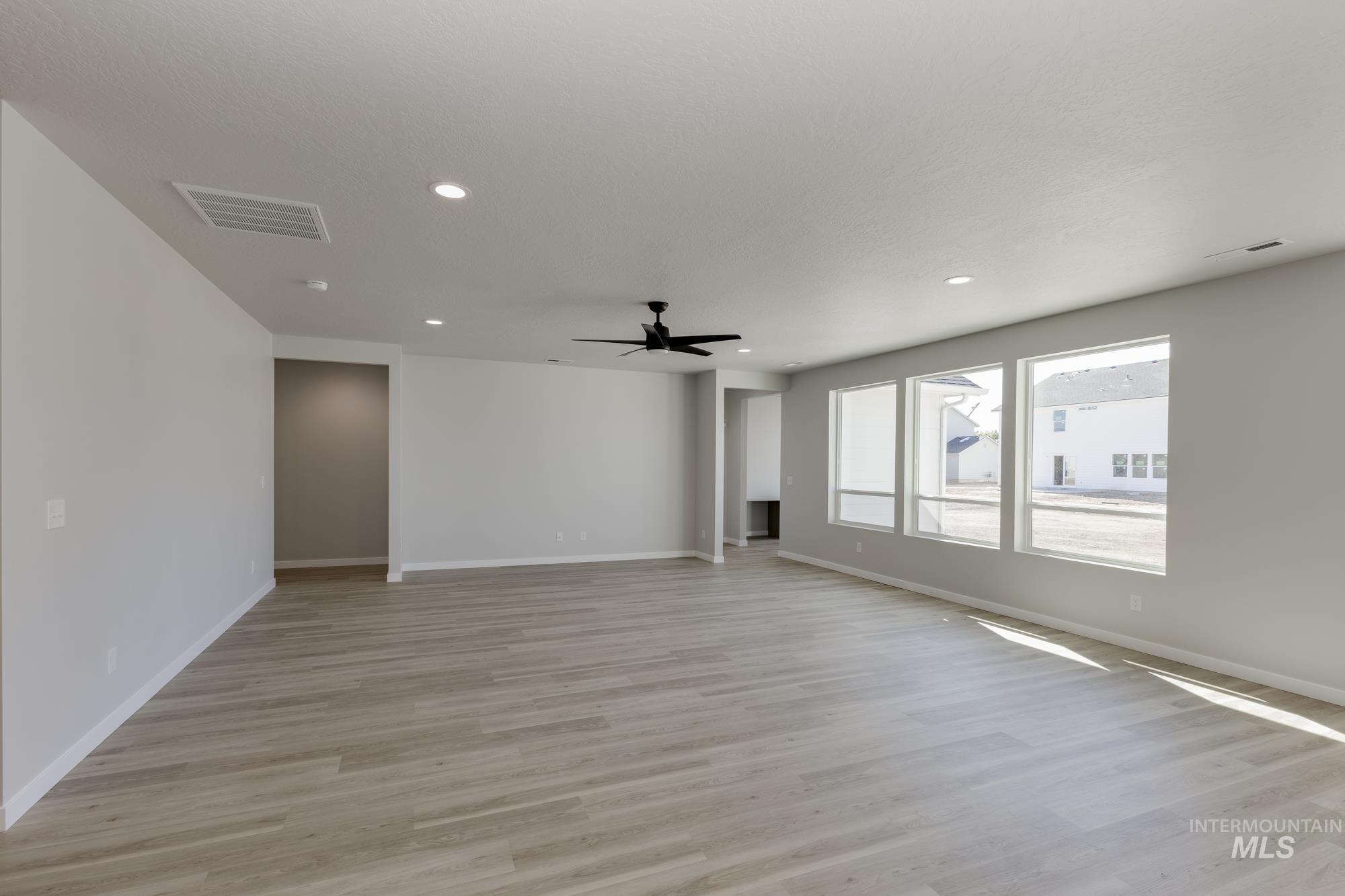 Empty room featuring light wood-style floors, recessed lighting, and ceiling fan