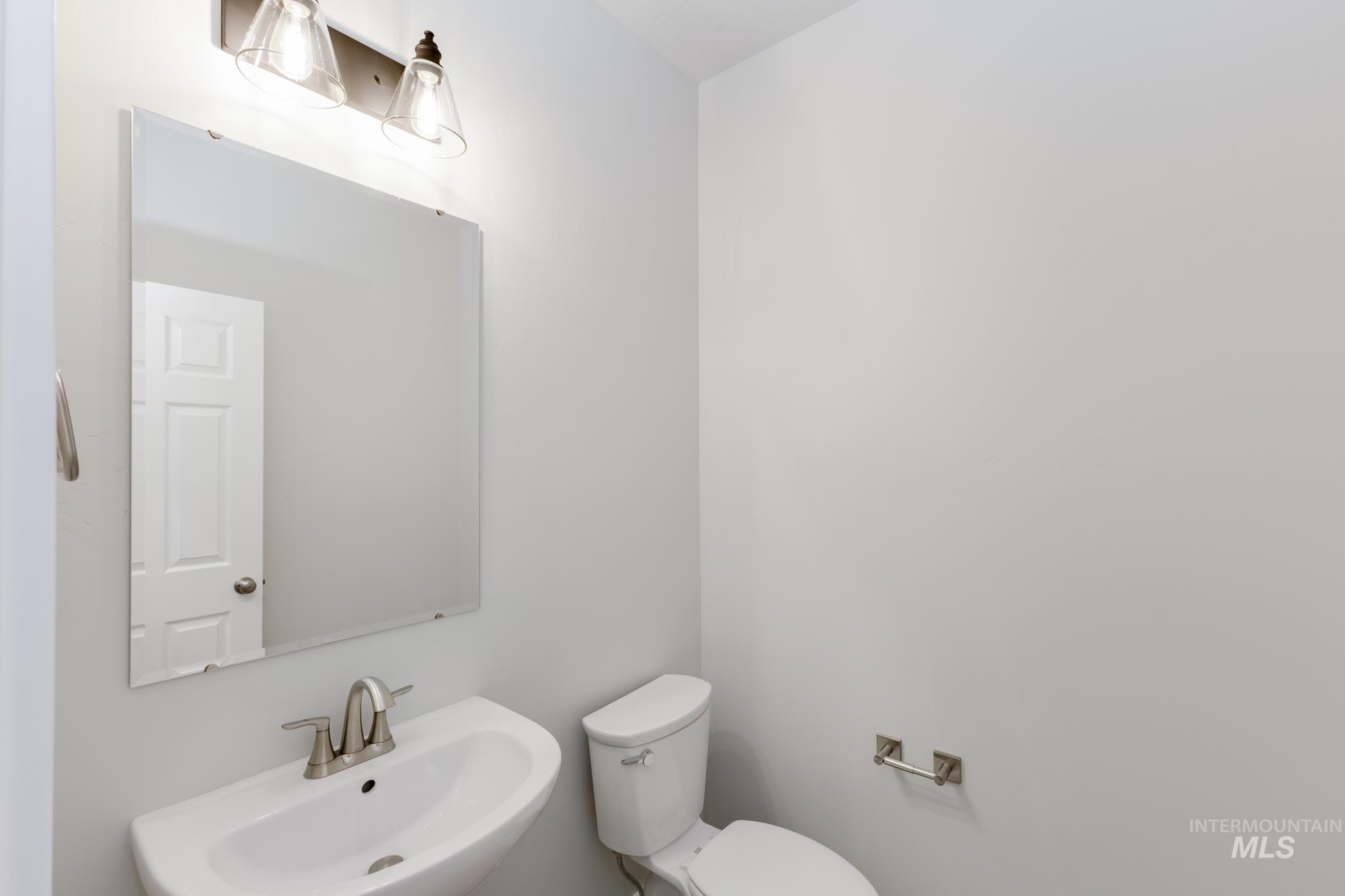 Half bathroom with a sink and toilet