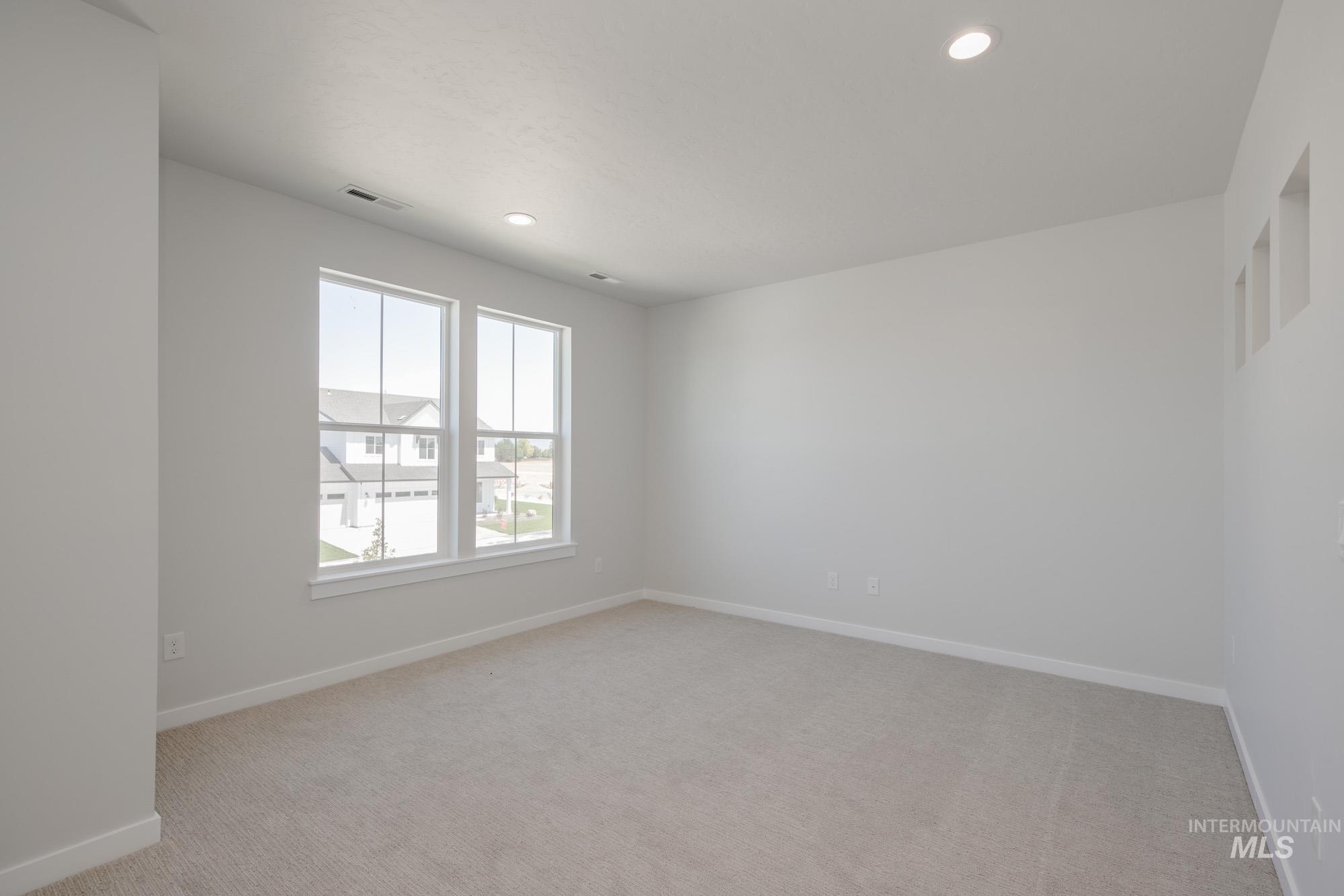 Unfurnished room featuring light carpet and recessed lighting