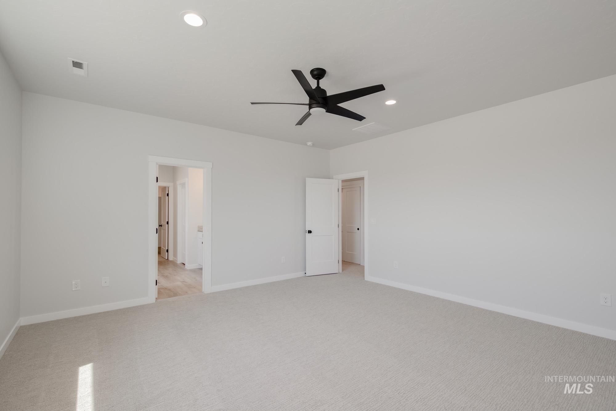 Unfurnished bedroom with light carpet, recessed lighting, and a ceiling fan