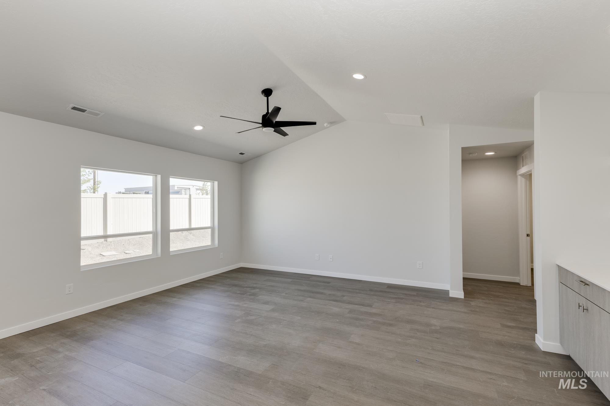 Unfurnished room with lofted ceiling, light wood-type flooring, recessed lighting, and ceiling fan
