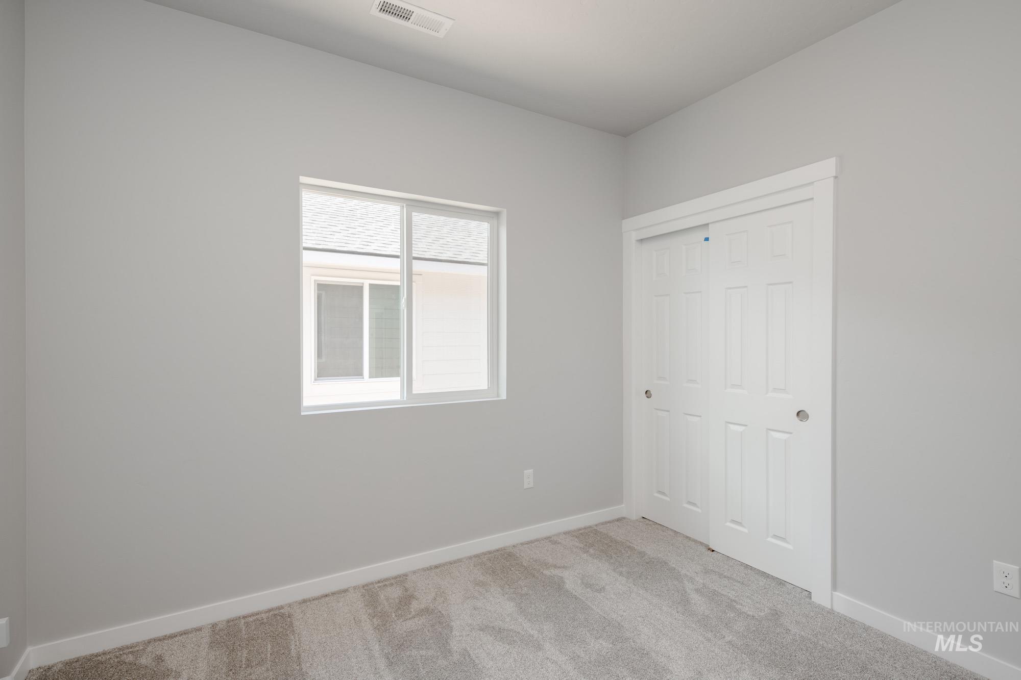 Unfurnished bedroom featuring carpet and a closet