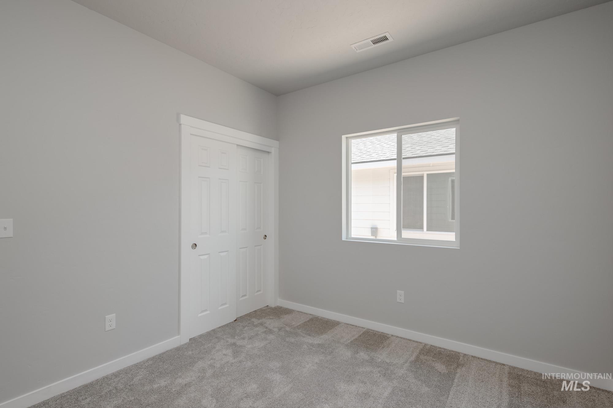 Unfurnished room with carpet and baseboards