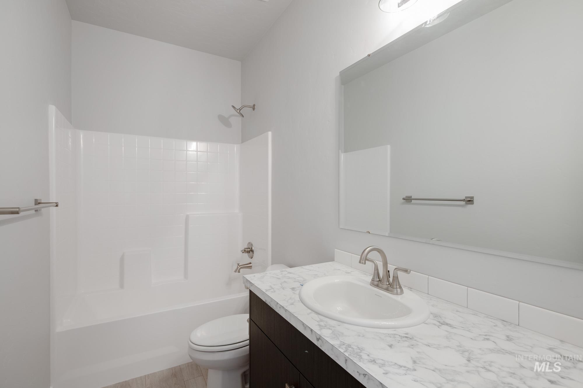 Bathroom featuring washtub / shower combination and vanity