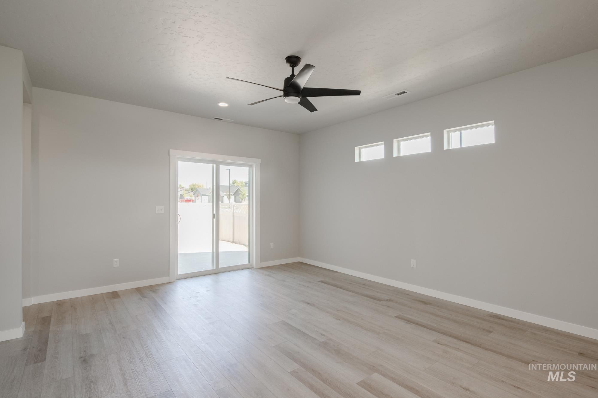 Spare room featuring light wood-type flooring and a ceiling fan