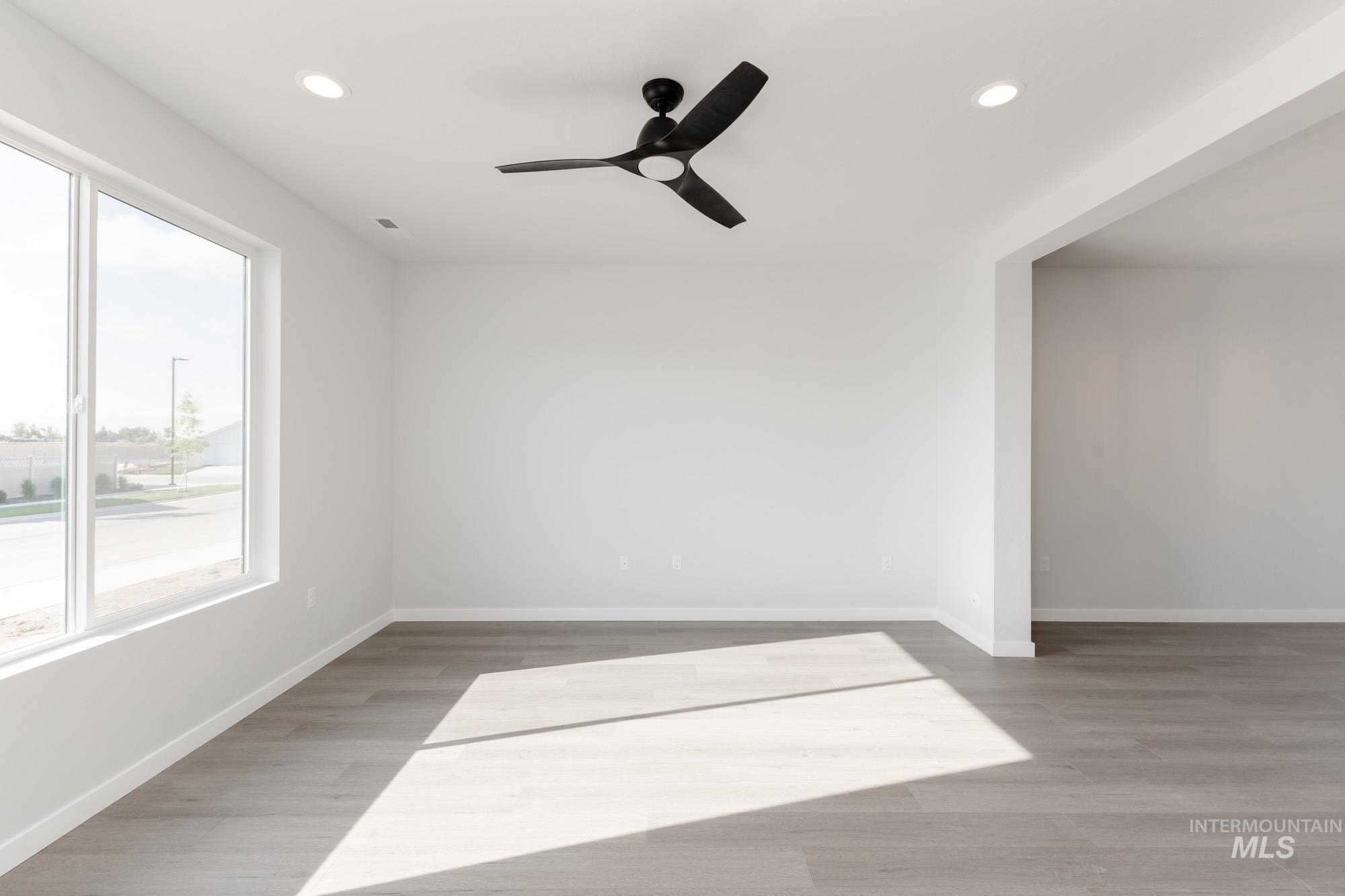 Empty room featuring light wood-style floors, recessed lighting, and a ceiling fan