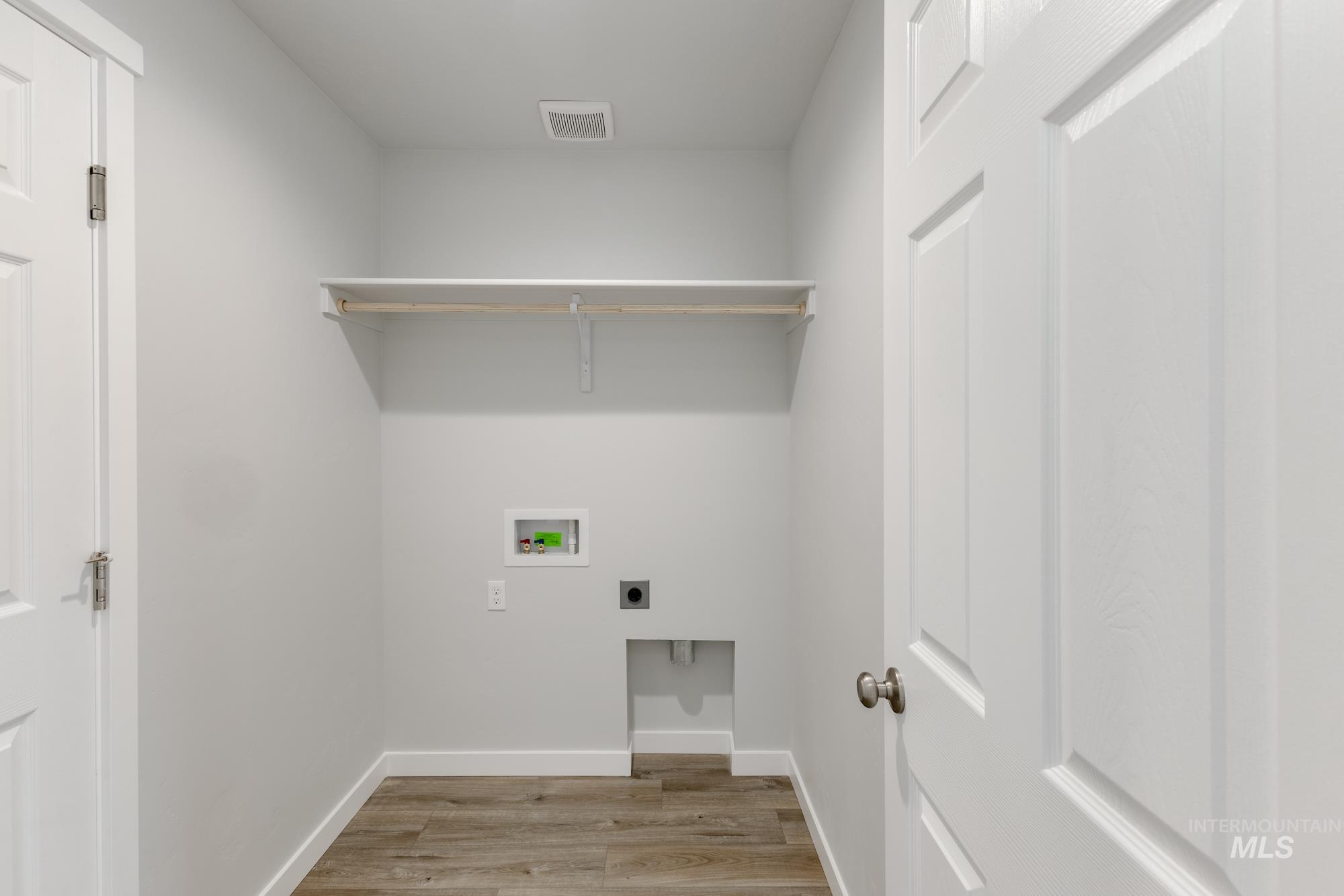 Washroom featuring light wood-type flooring, washer hookup, and electric dryer hookup