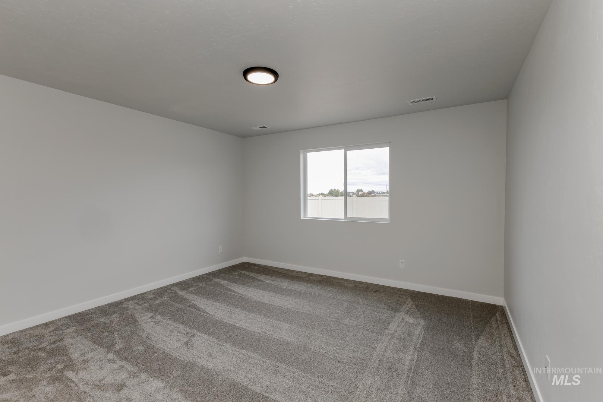 Unfurnished room with light colored carpet