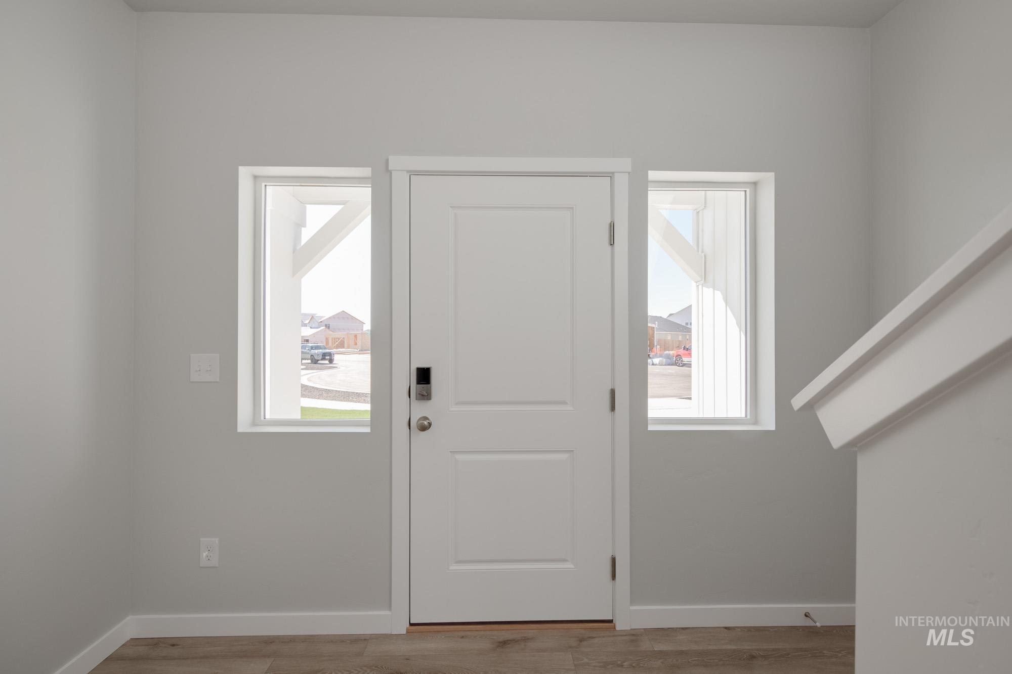 Foyer entrance with plenty of natural light and light wood-style floors