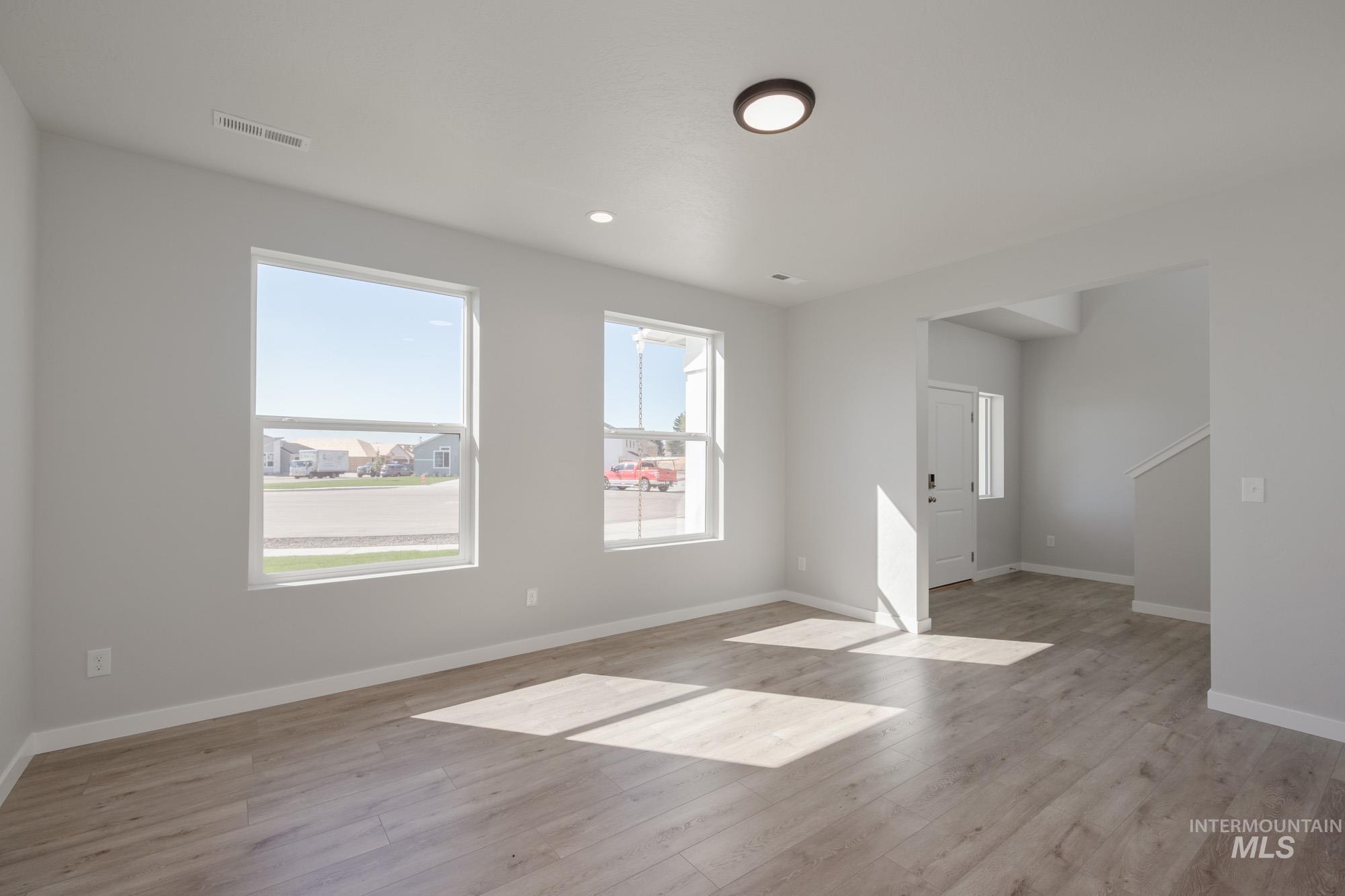 Empty room with light wood finished floors