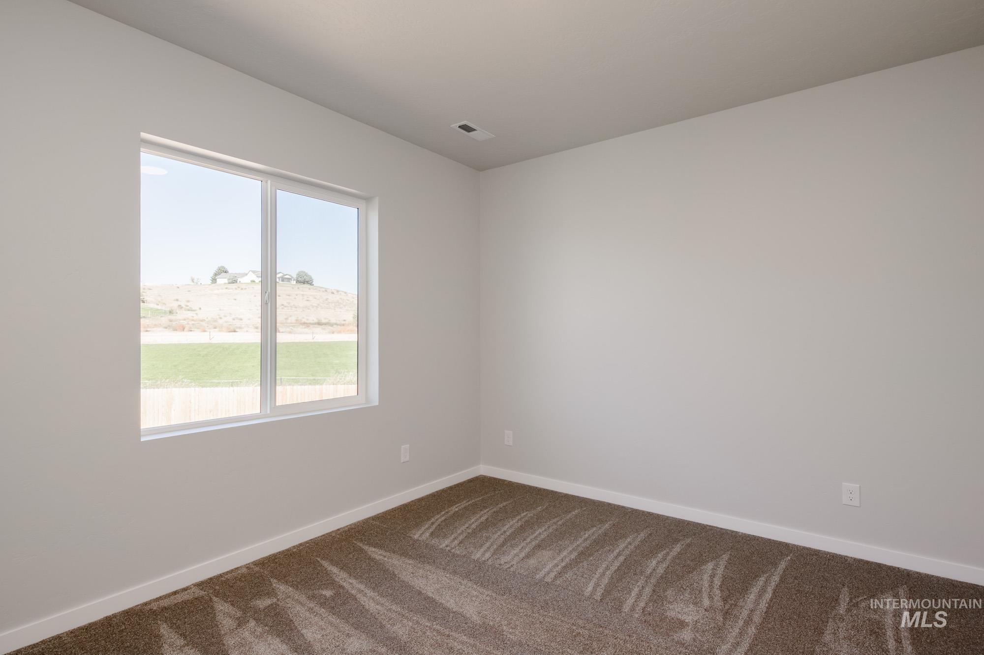 Empty room with carpet flooring and baseboards
