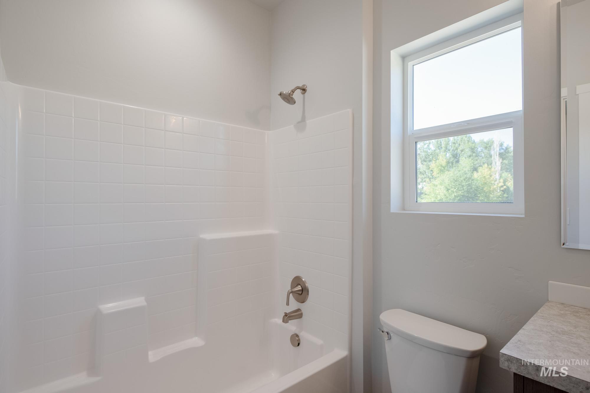 Bathroom featuring vanity and shower / bathtub combination