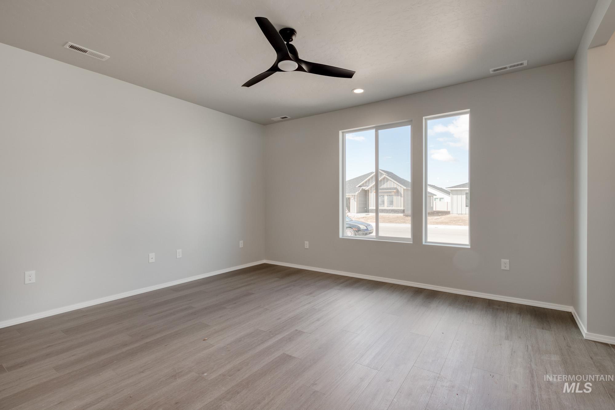 Unfurnished room featuring ceiling fan, light wood-style flooring, and recessed lighting