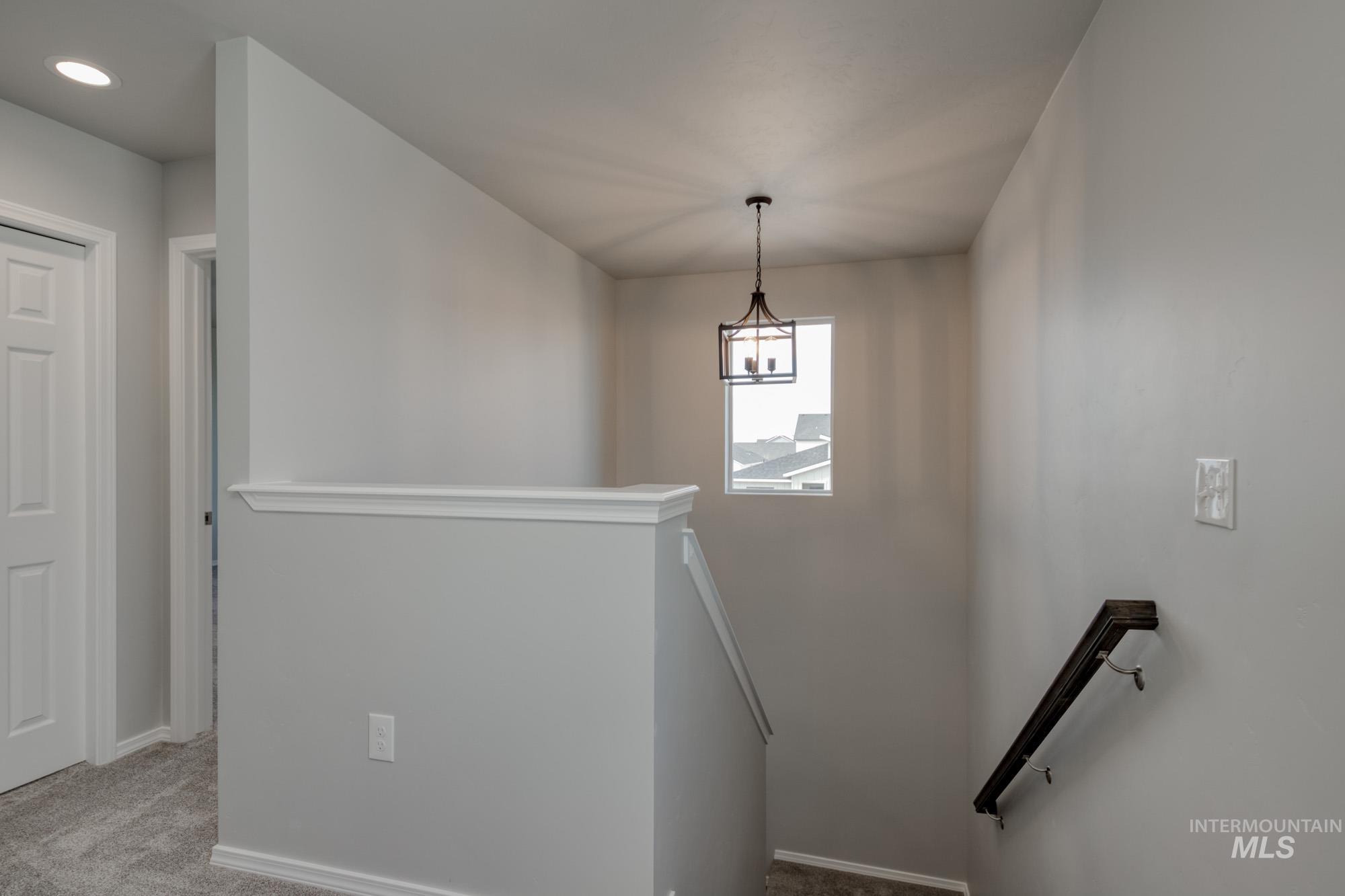 Stairs featuring carpet flooring and baseboards