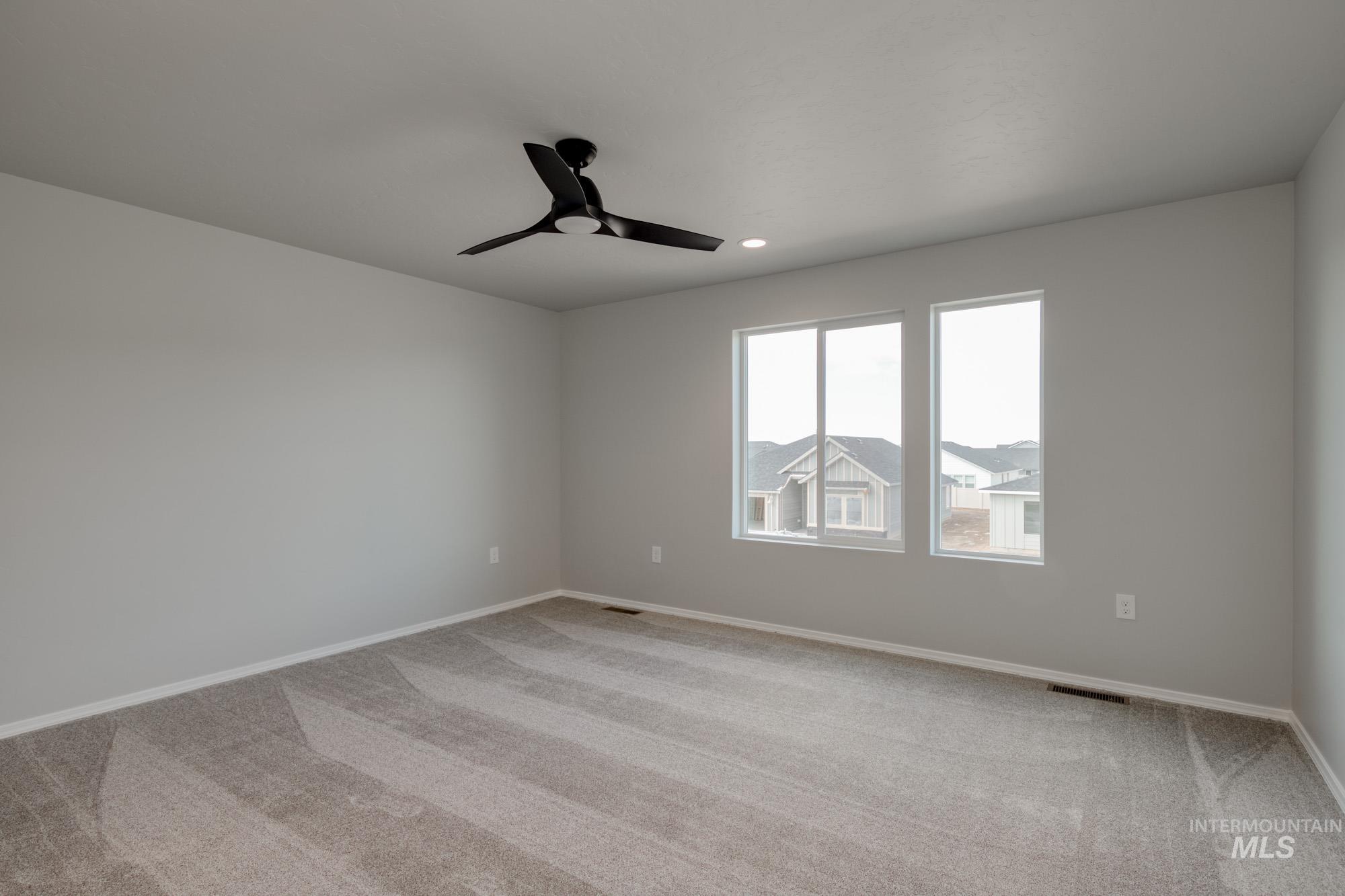 Unfurnished room with light colored carpet, ceiling fan, and recessed lighting