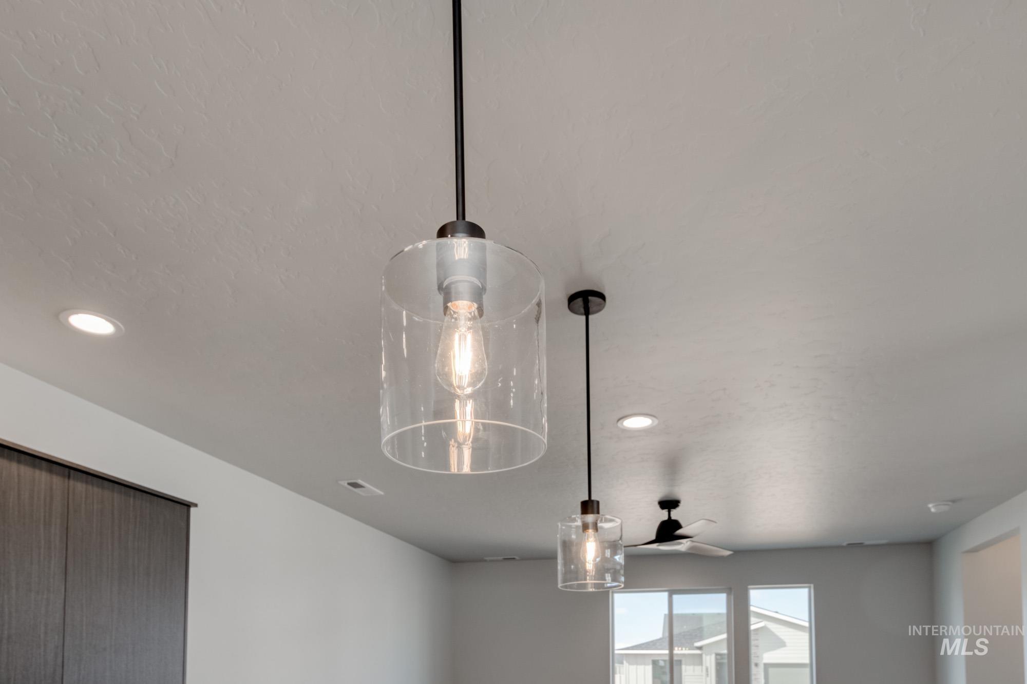 Detailed view of recessed lighting and a ceiling fan