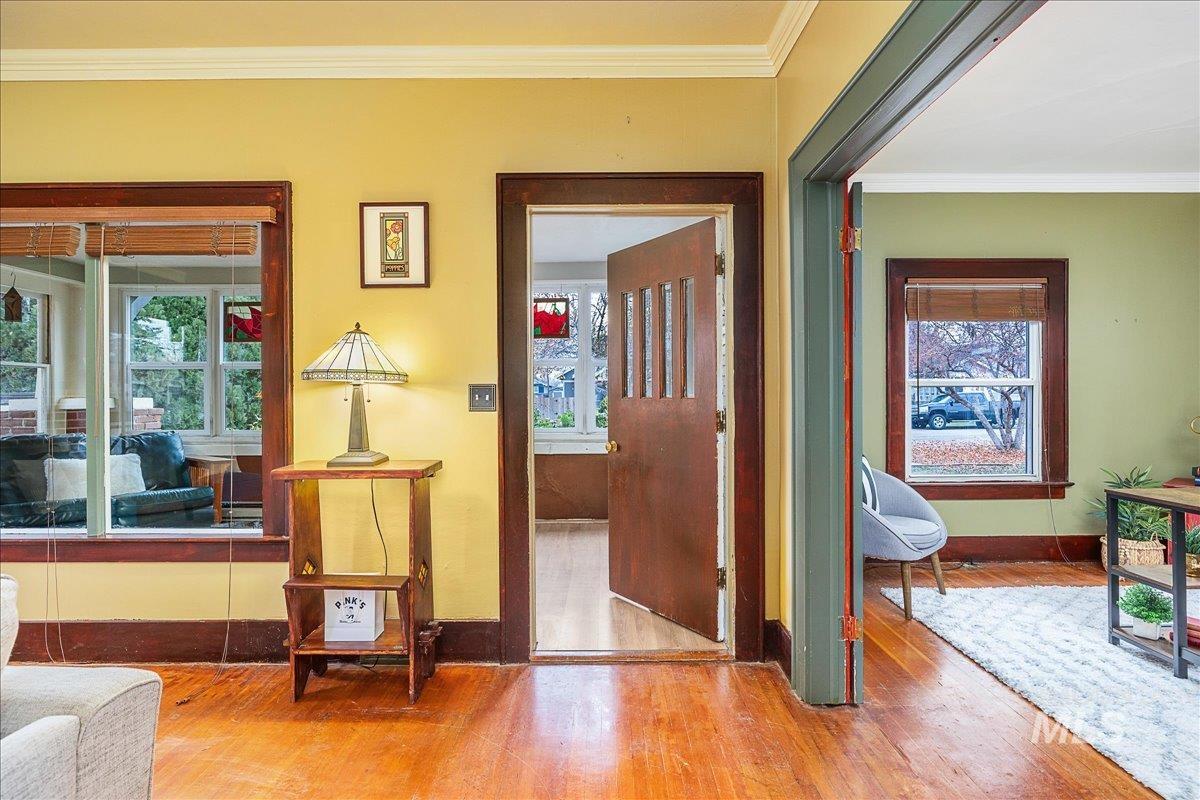 Hall featuring ornamental molding and hardwood / wood-style floors