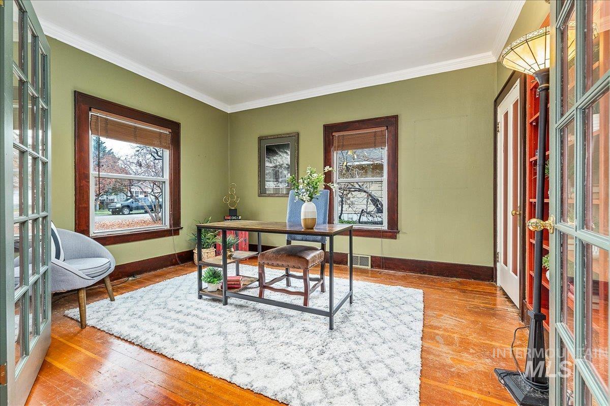 Office area with wood-type flooring, crown molding, and french doors