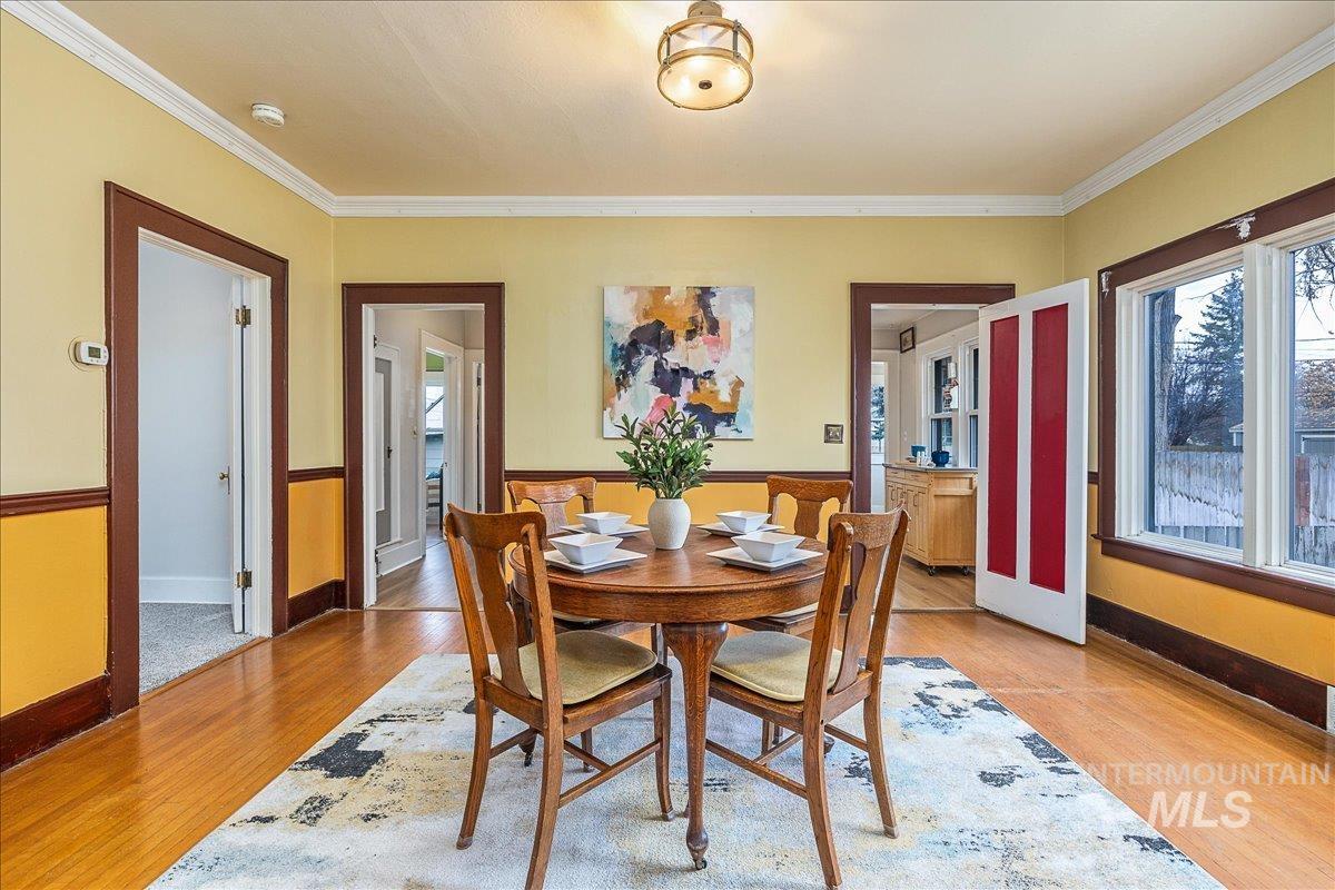 Dining room featuring light wood-style flooring and ornamental molding