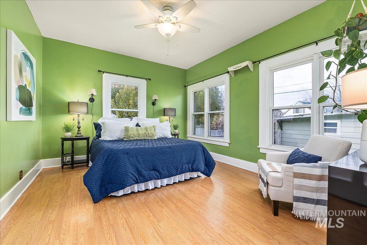 Bedroom with light wood-style floors and a ceiling fan