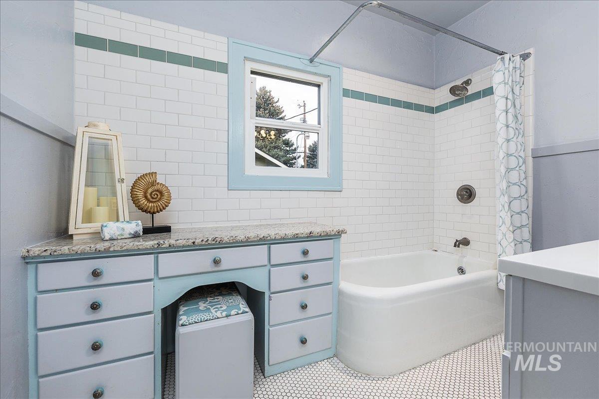 Bathroom with vanity and shower / bath combo with shower curtain