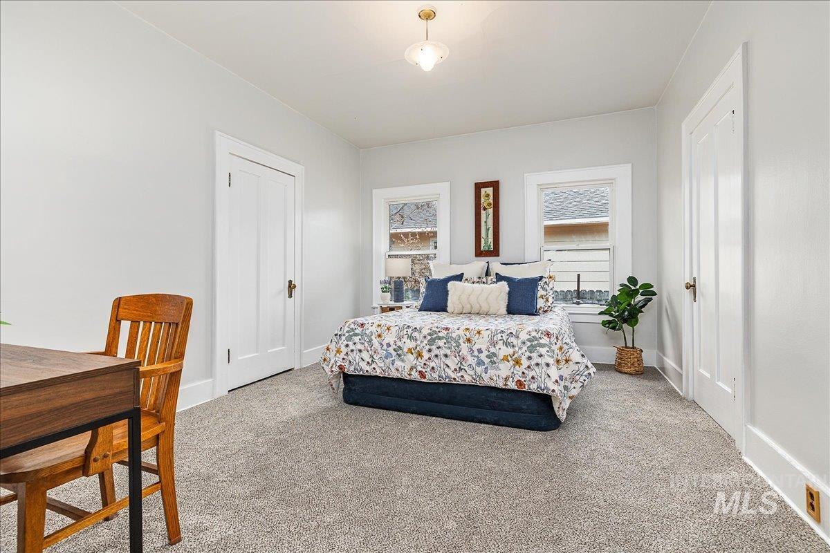 Carpeted bedroom featuring baseboards