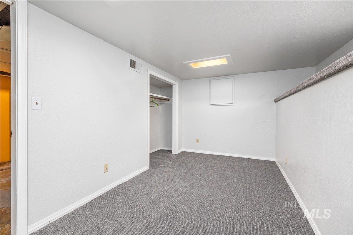 Unfurnished bedroom featuring carpet floors, a closet, and a textured wall