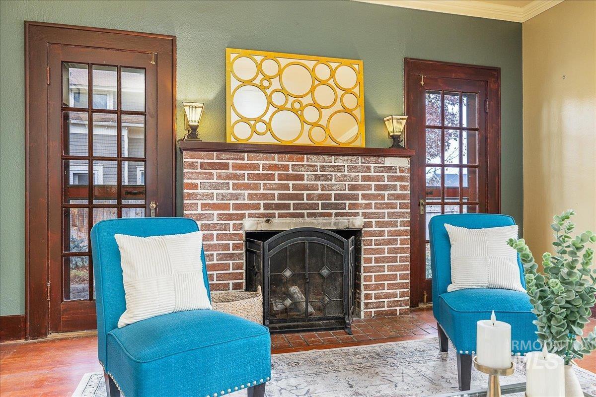 Living area featuring a fireplace and crown molding
