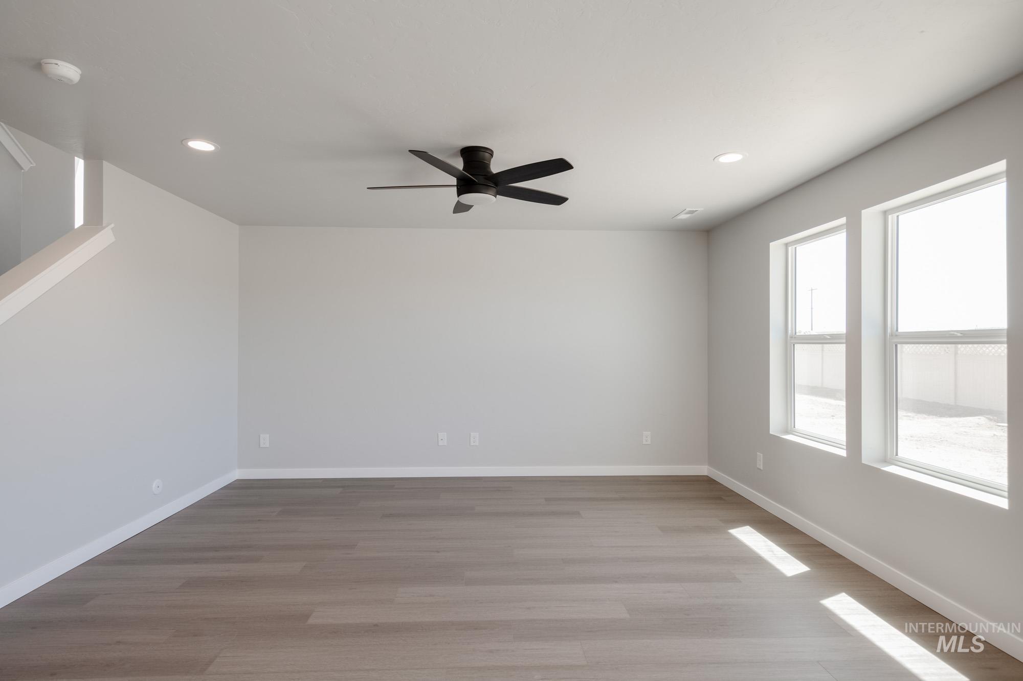 Unfurnished room featuring light wood-style floors, recessed lighting, and ceiling fan