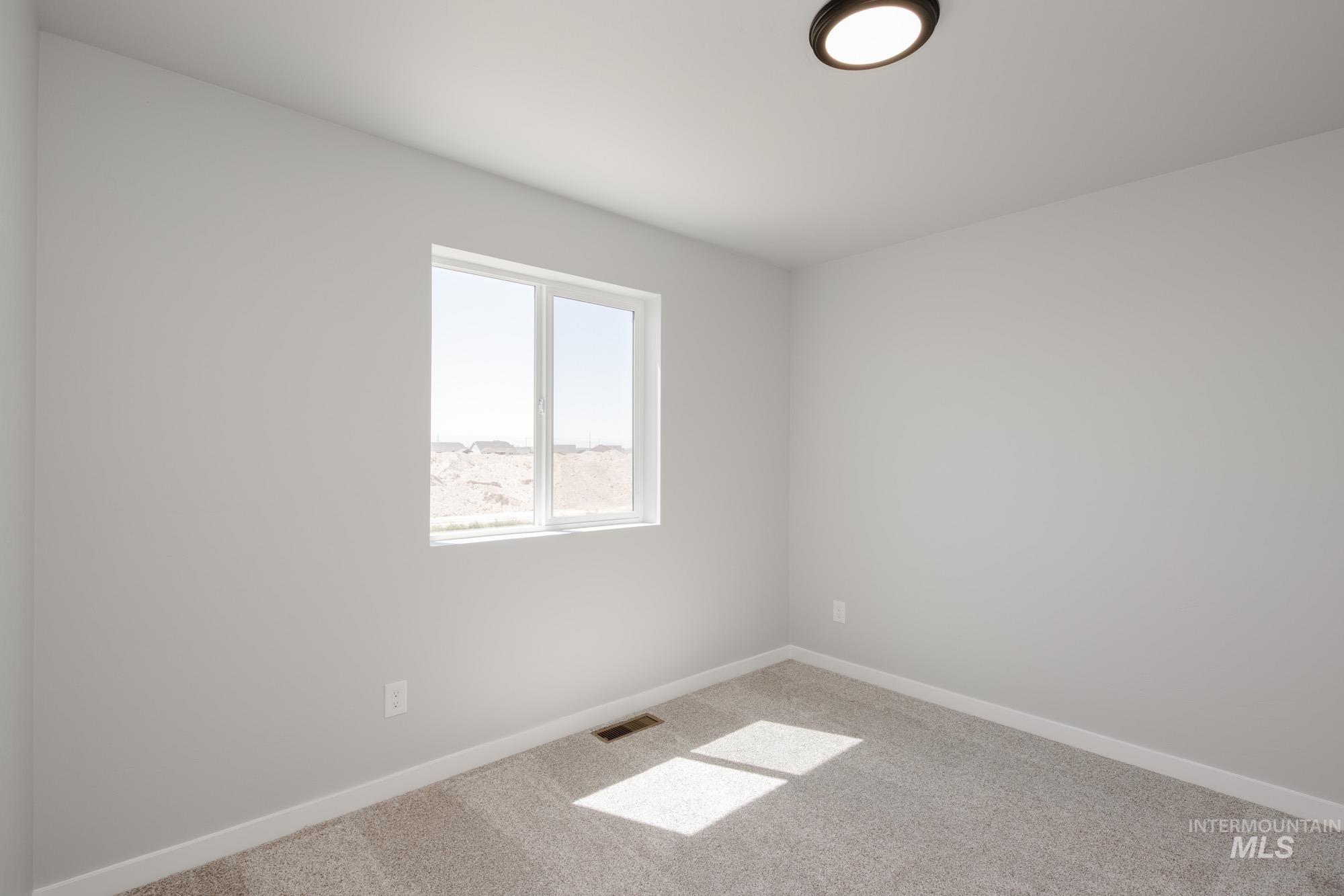 Empty room with carpet floors and baseboards