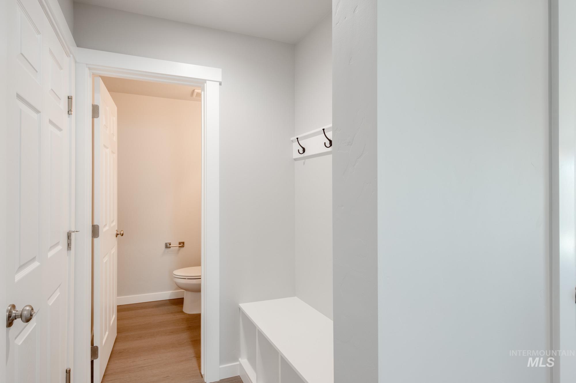 Mudroom featuring light wood-style floors and baseboards
