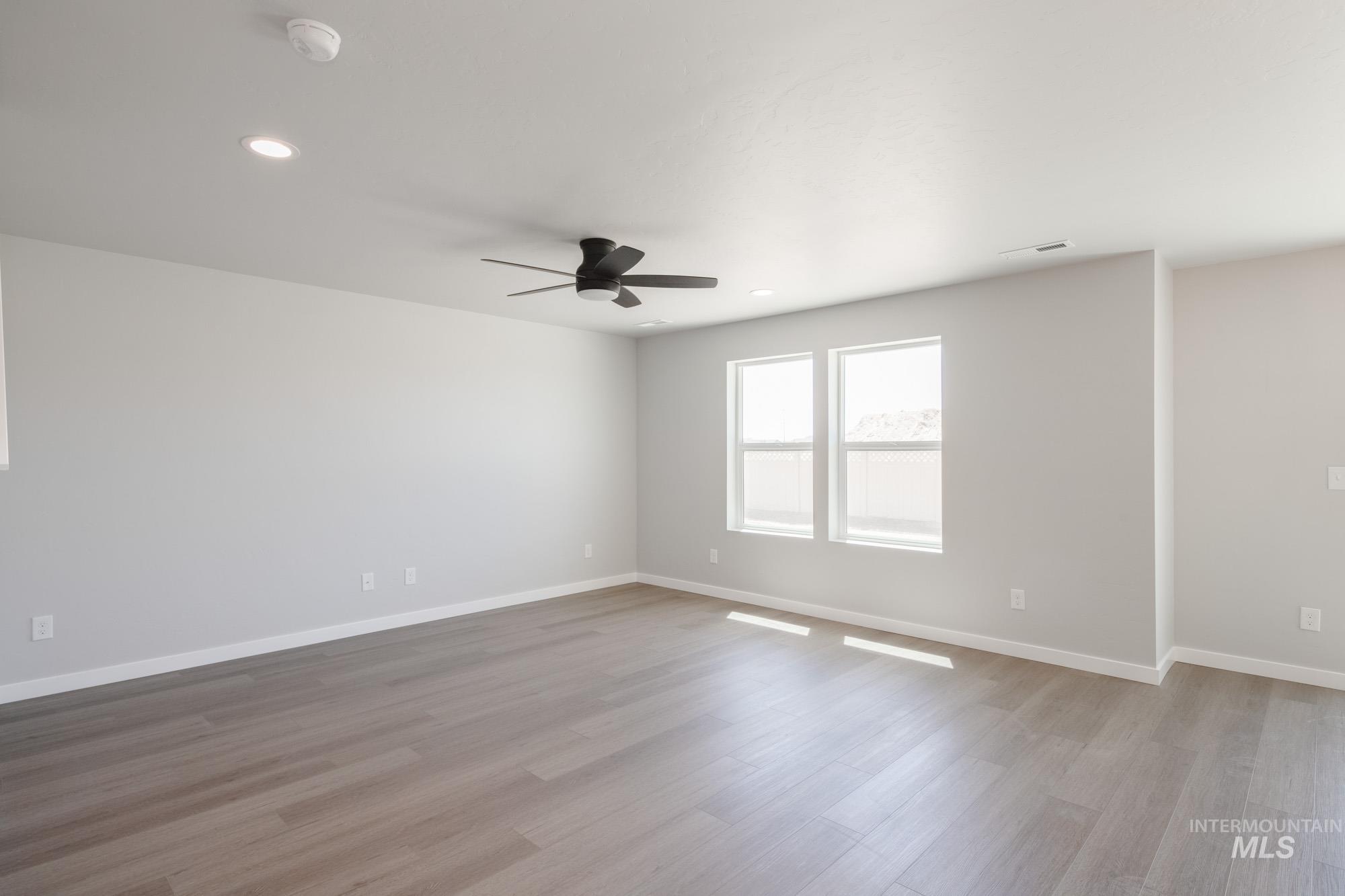 Unfurnished room with light wood finished floors, recessed lighting, and ceiling fan