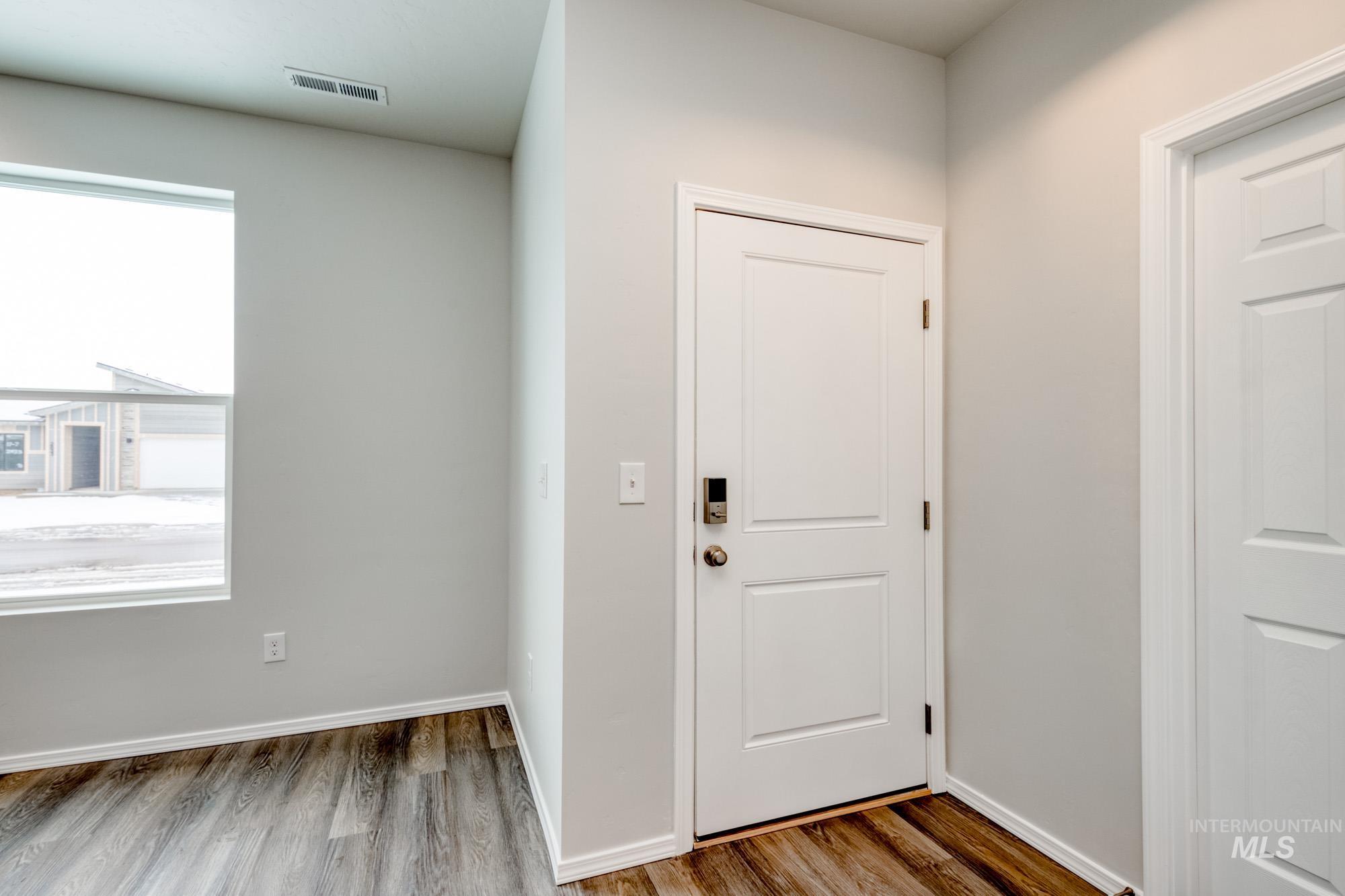 Entrance foyer featuring wood finished floors and baseboards