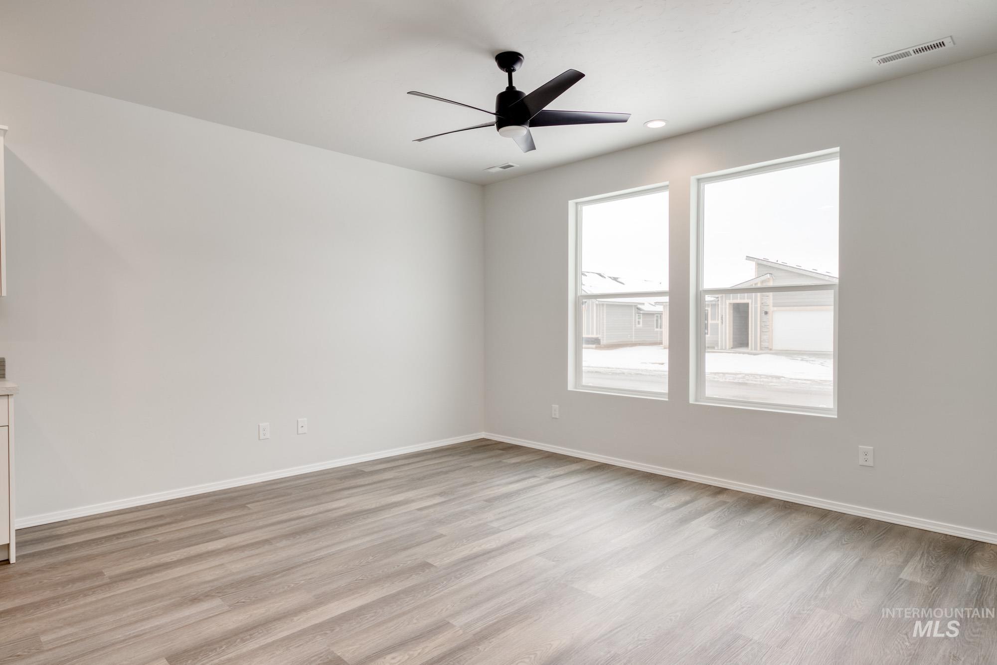 Spare room with light wood-type flooring, ceiling fan, and recessed lighting