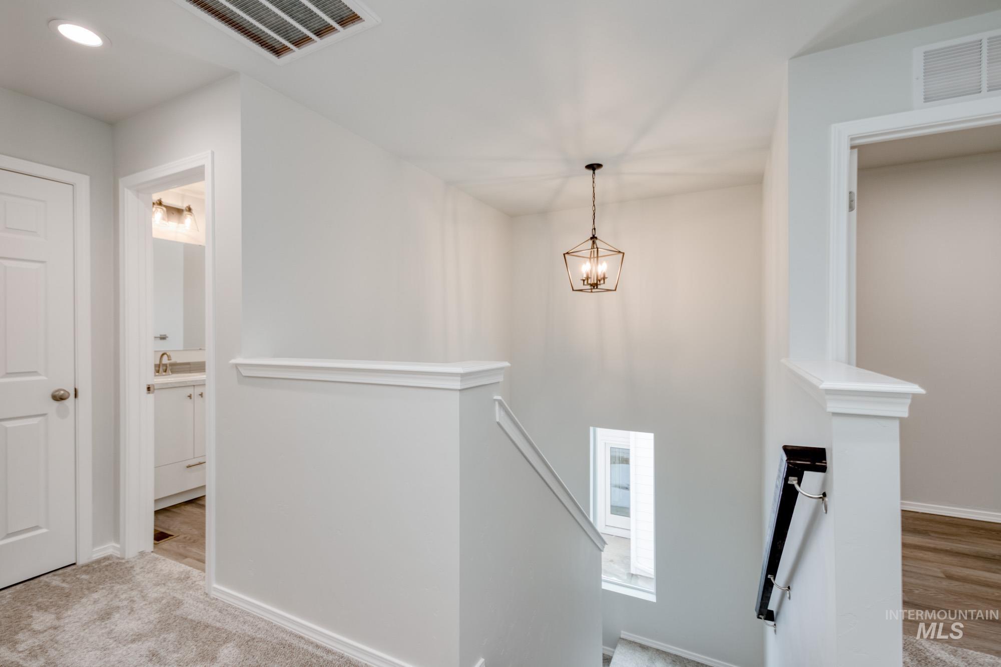 Stairs with carpet flooring, recessed lighting, and a chandelier