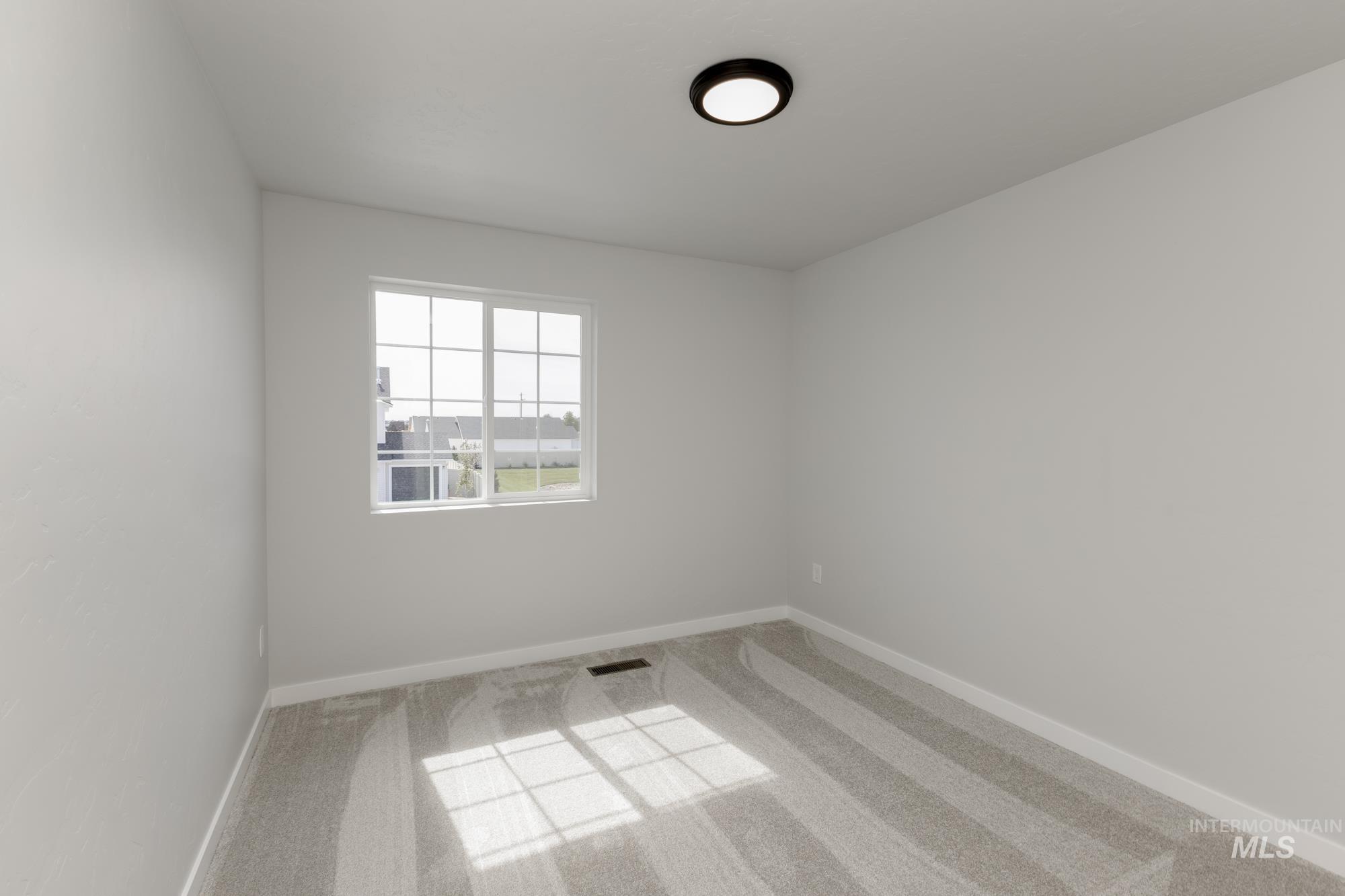 Spare room with carpet floors and baseboards