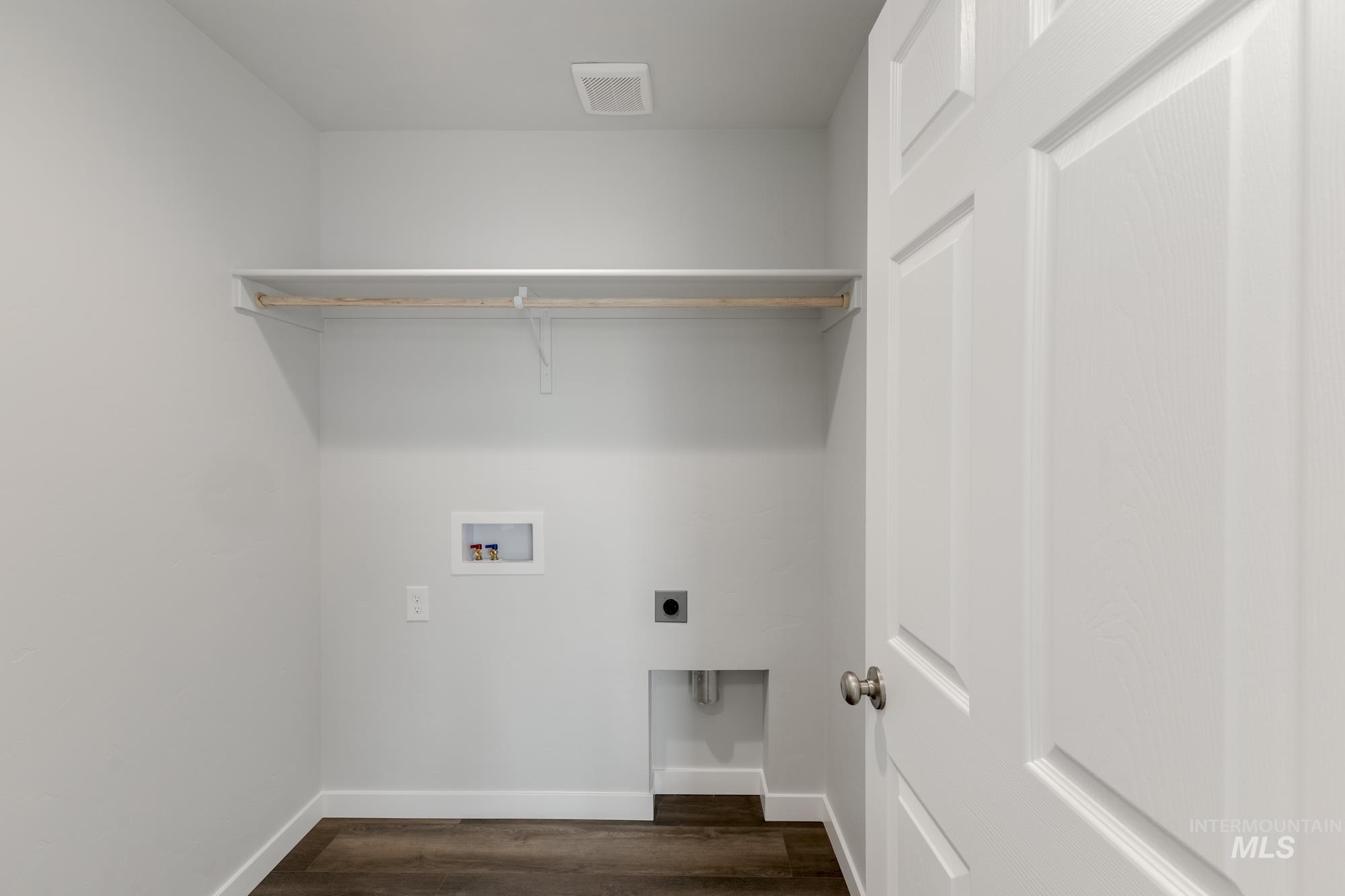 Washroom featuring dark wood-style floors, hookup for an electric dryer, and hookup for a washing machine