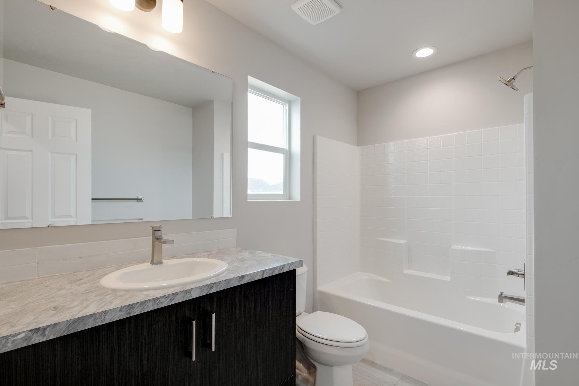 Full bathroom with vanity and shower / tub combination